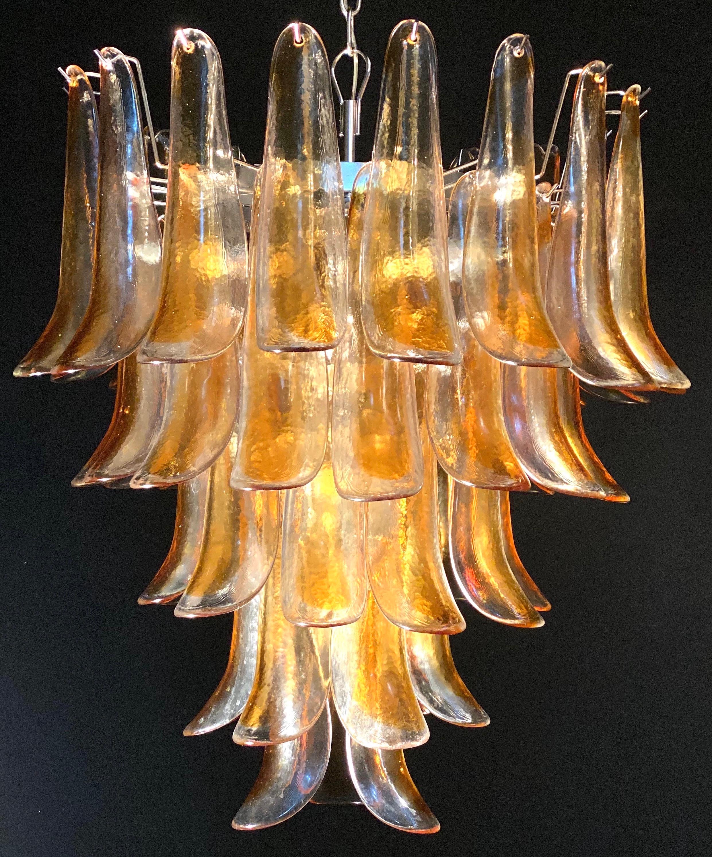 Italian vintage Murano chandelier made by 52 clear amber glass petals supported by a chrome frame.
The clear amber color of the glasses create a fabulous warm light effect.
Period: 1970s
Dimensions: 55.10 inches (140 cm) height with chain; 29.50