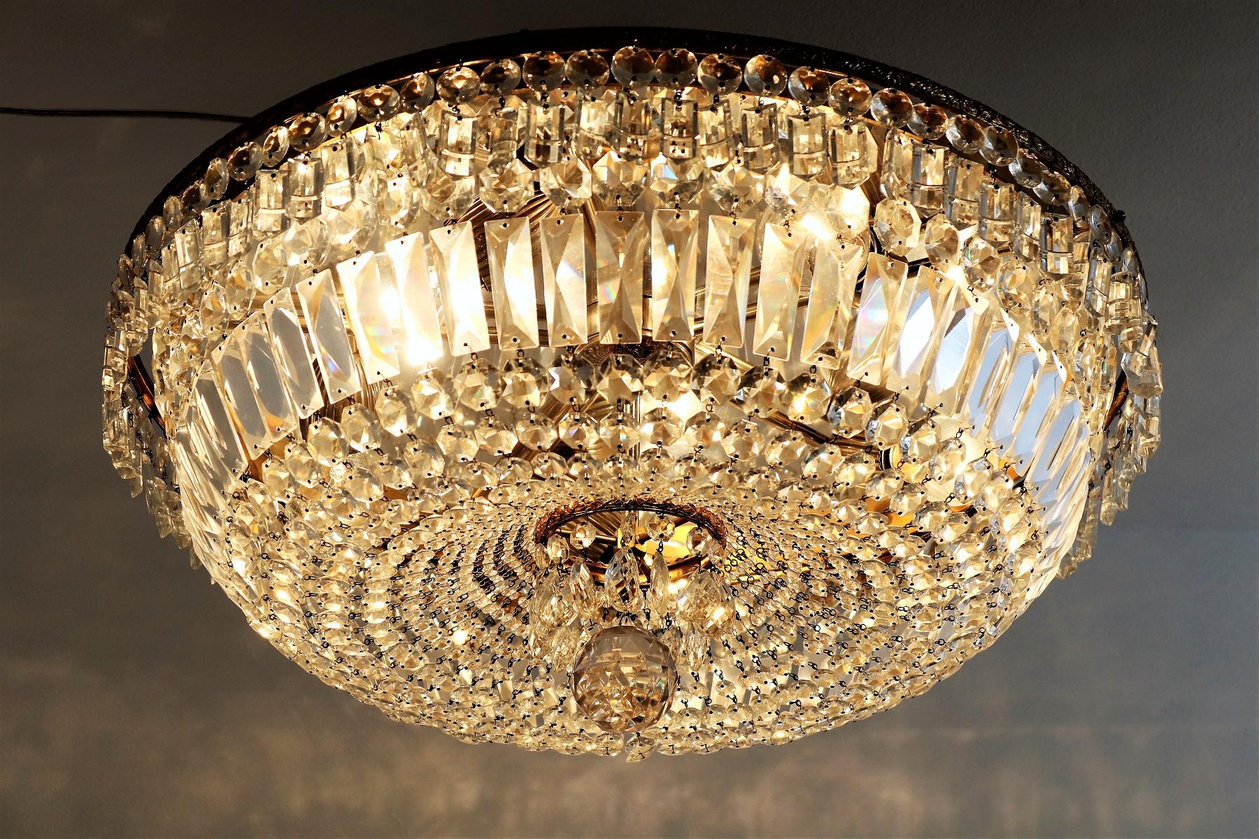 Beautiful and big Murano flush mount chandelier with crystal glasses and double brass frame.
Made in Italy during the 1950s.
This piece is coming originally from a dancing ballroom.
When the sun shines on it or it's lit up, the crystals are shining