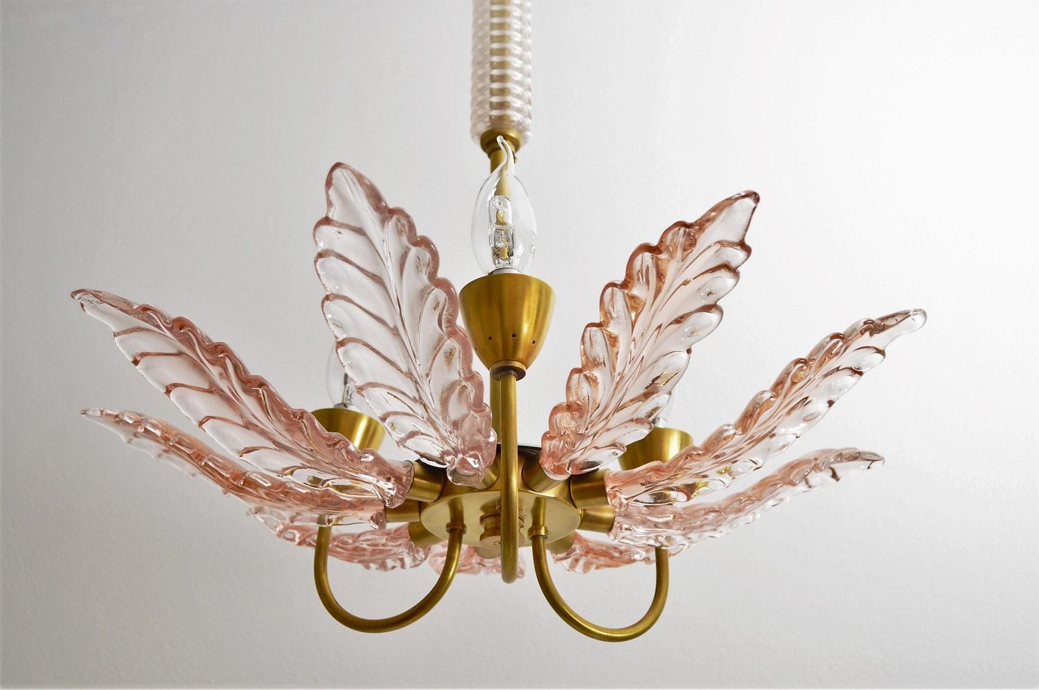 Magnificent and rare Italian chandelier made of light pink or rose colored Murano glass in the form of a flower.
The glass petals are handmade and differ slightly one from the other.
The lamp's frame is made entirely of brass parts, which have