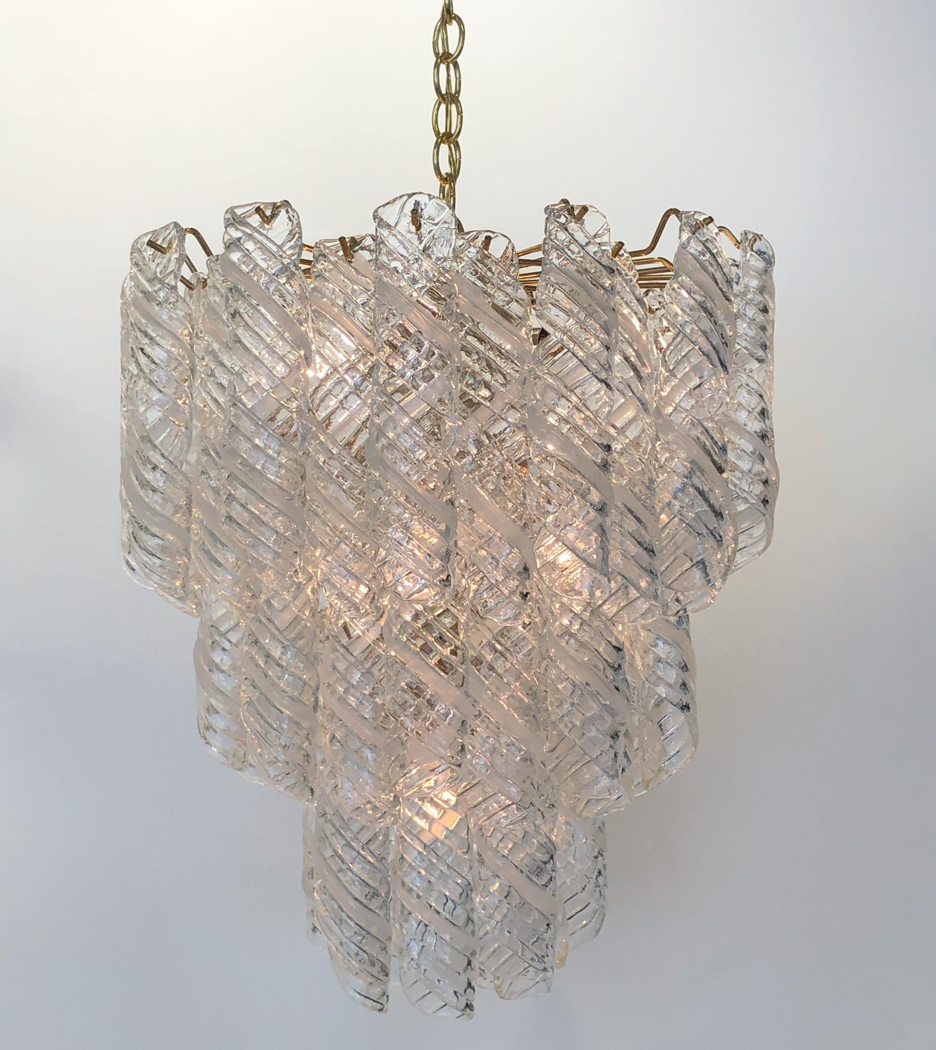 A glamorous 1970s Italian Murano glass and polish brass chandelier designed by Carlo Nason for Mazzega. Each piece of glass is handblown. The chandelier has been newly rewired. The chandelier takes six regular Edison light bulbs. We can extend the
