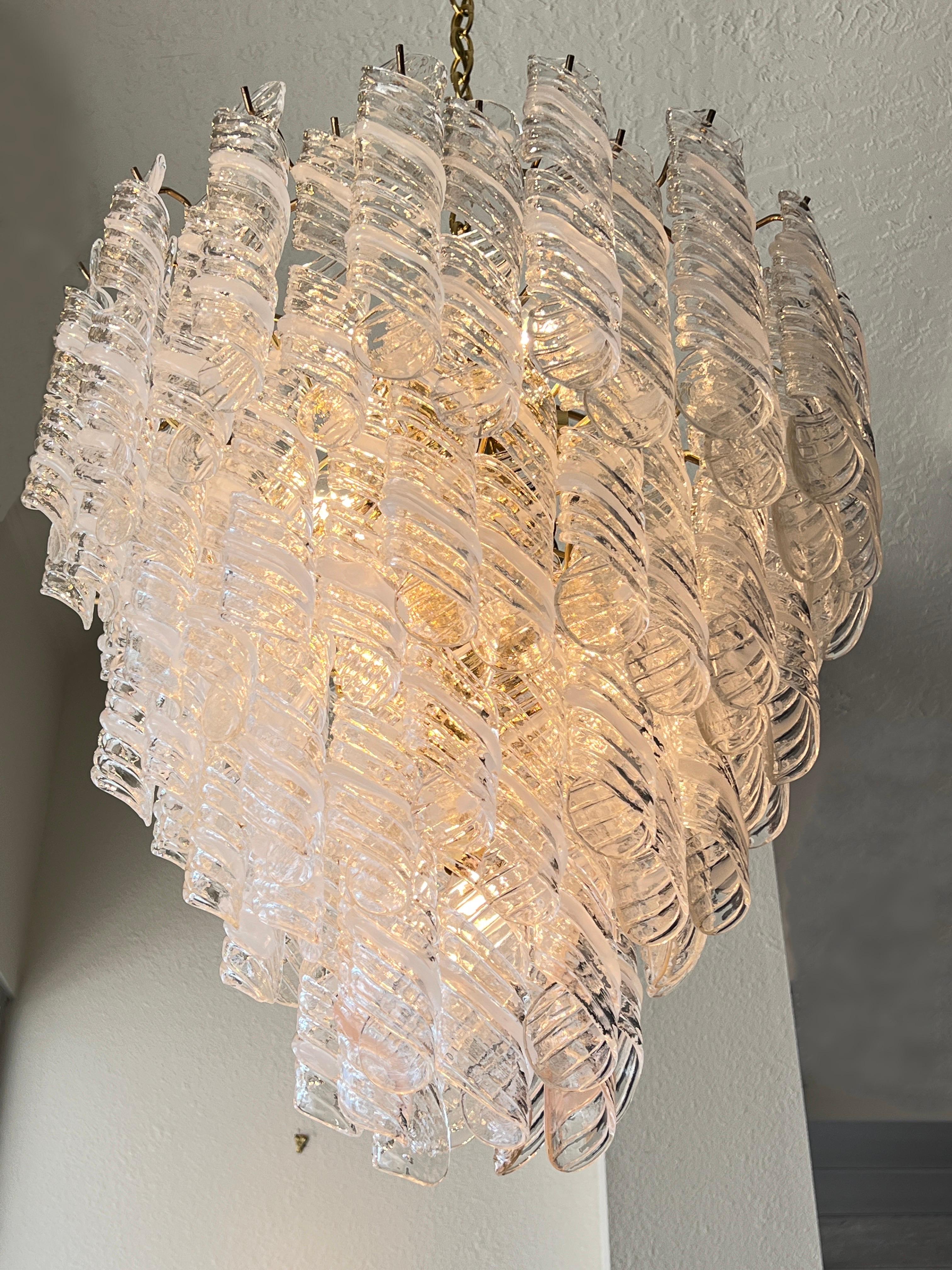 1970’s Italian hand blown Murano glass and brass four tier chandelier by Mazzega. 
Out of a glamorous Palm Springs home. The prisms are hand blown. Four have a little blush, that go at the bottom tier( see detail photos). 
Newly rewired, it takes