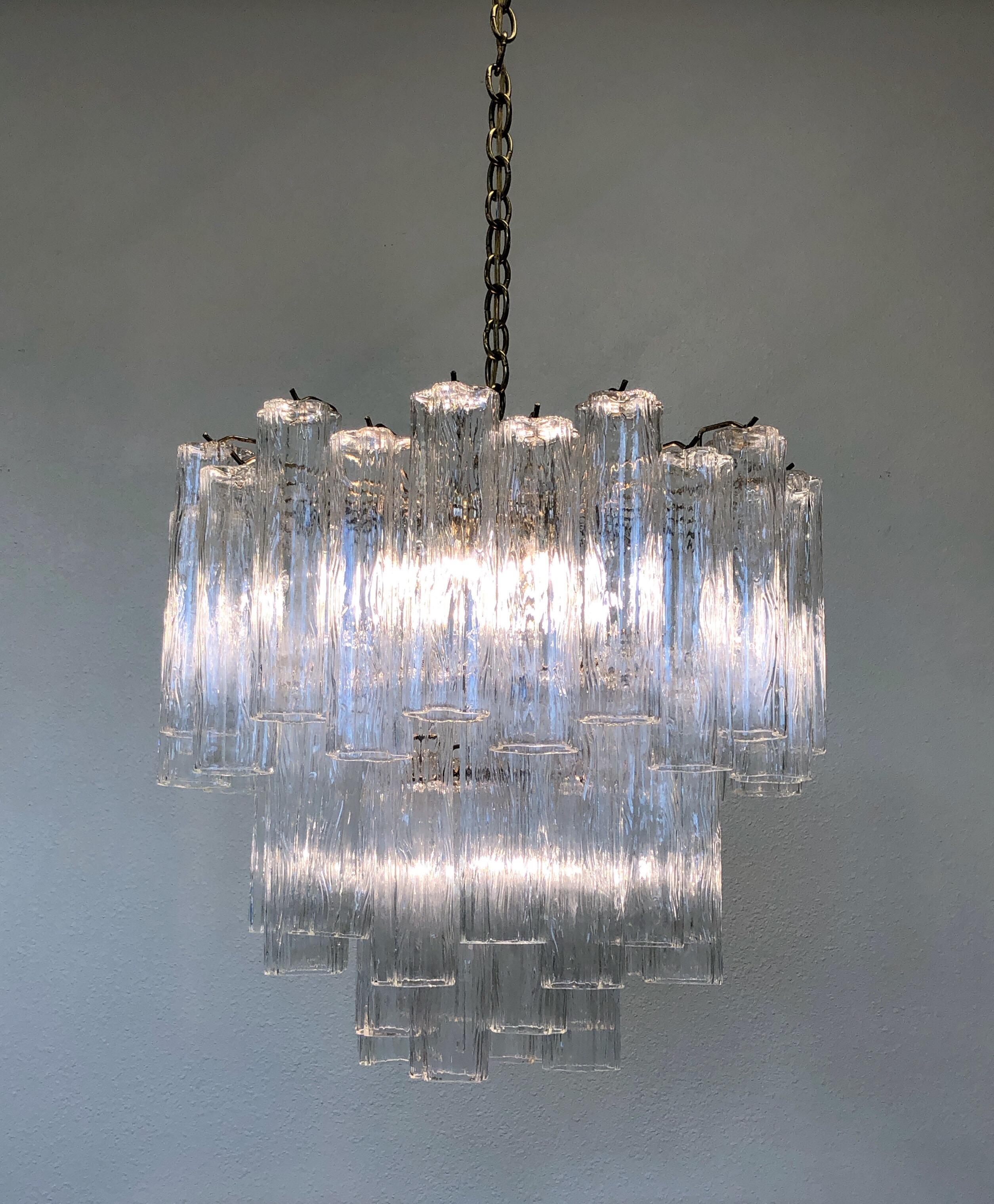 For your consideration a glamorous 1970s Italian Murano glass and brass “Tronchi” chandelier by Venini. Newly rewired. The chandelier takes eight candelabra light bulbs and one regular Edison light bulb.
Dimensions without chain- 24”diameter
