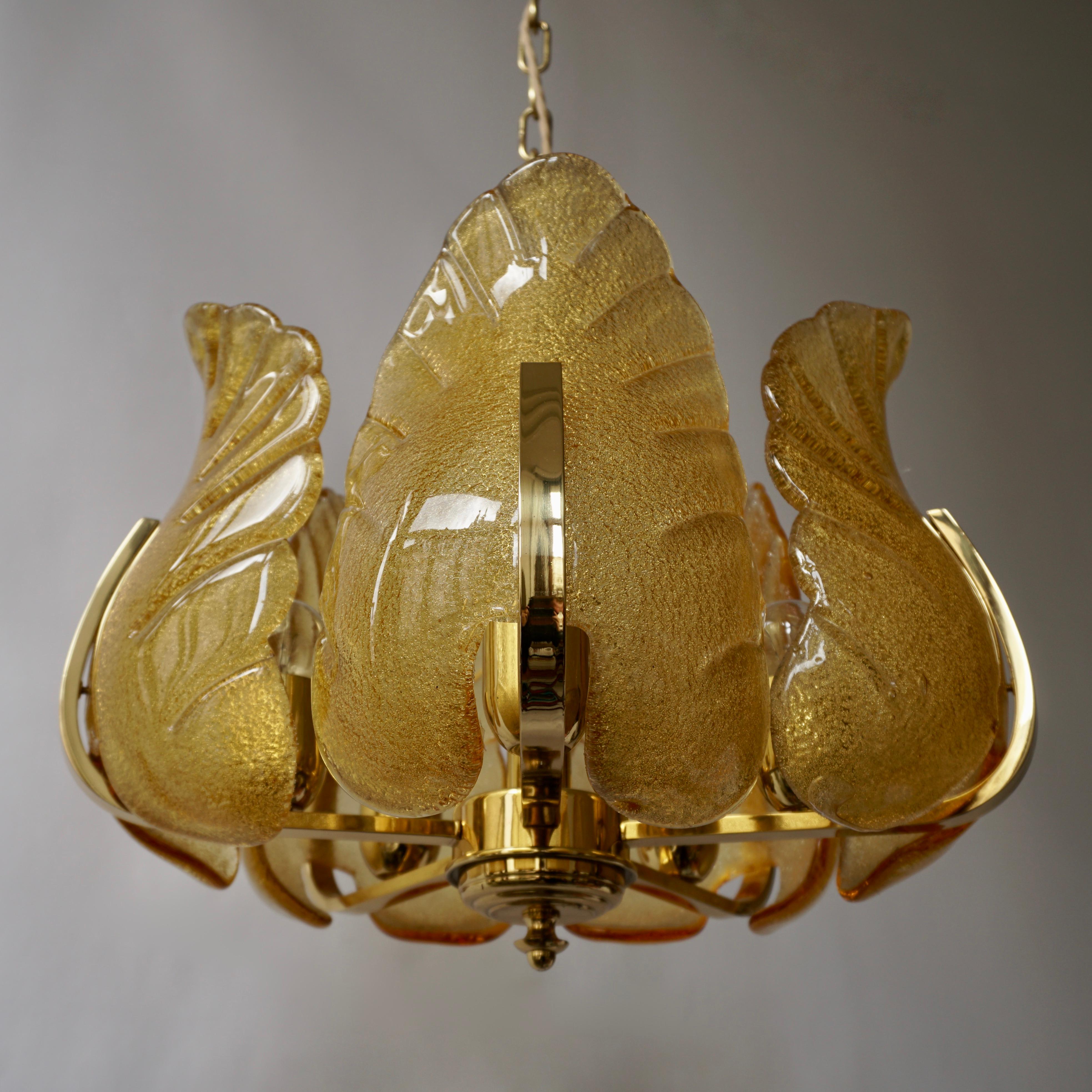 Italian amber Murano glass and brass chandelier.
Diameter 43 cm.
Height fixture 35 cm.
Total height including the chain and canopy 88 cm. 
The light requires five single E27 screw fit lightbulbs (60Watt max.)
Weight 8 kg.