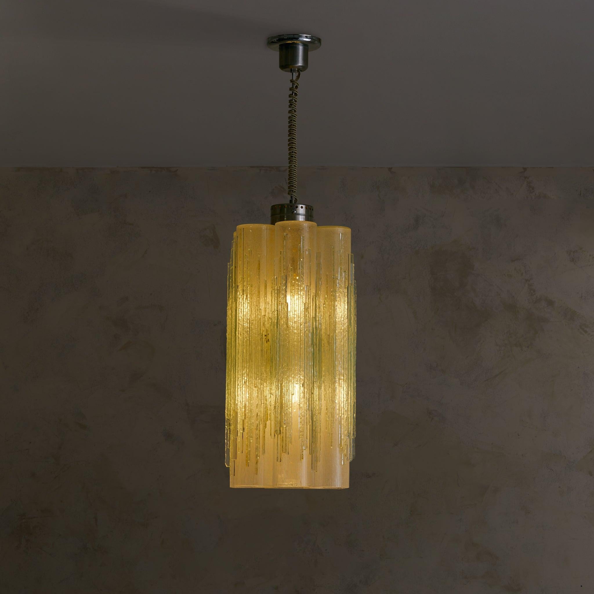 A 1970s Italian chandelier attributed to Albano Poli for Poliarte. Seven frosted Murano glass tubes, each hand-blown with a distinctive icicle-like texture, are suspended from polished chrome hardware and a wrapped textile cord—their surface