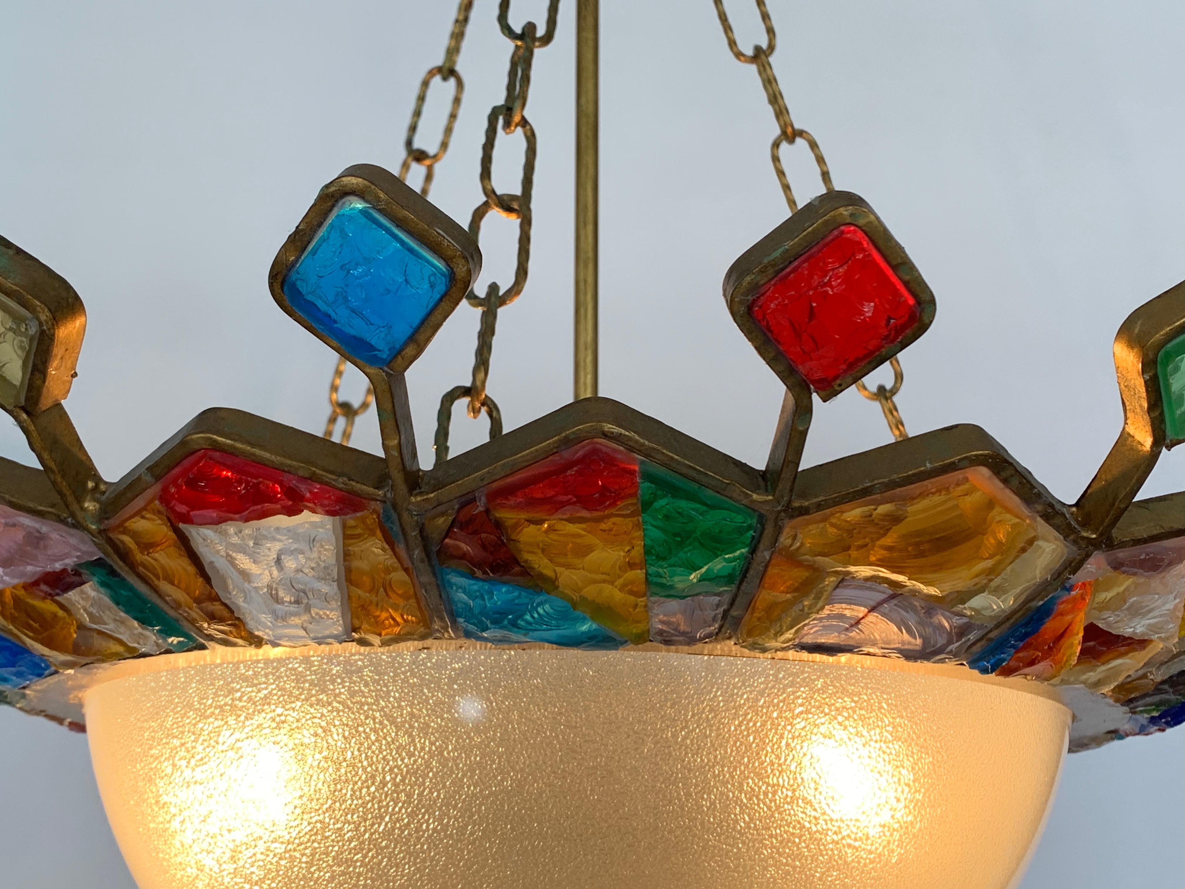 Murano glass chandelier designed and manufactured by Longobard in 1970. The structure of the chandelier is in hand-worked golden wrought iron with the insertion of thick colored hammered glass.


  