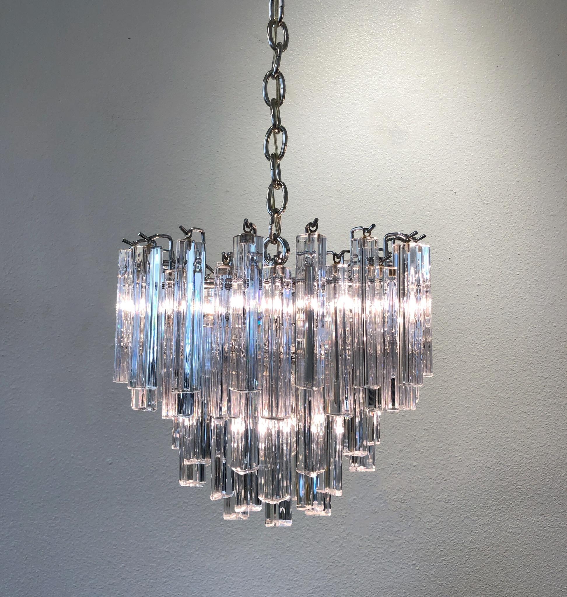 A glamorous small Italian clear Murano glass and chrome chandelier design by Venini n the 1970s. Newly rewired.

Dimensions: 15” diameter, 13.5” high. (dimensions not including chain).