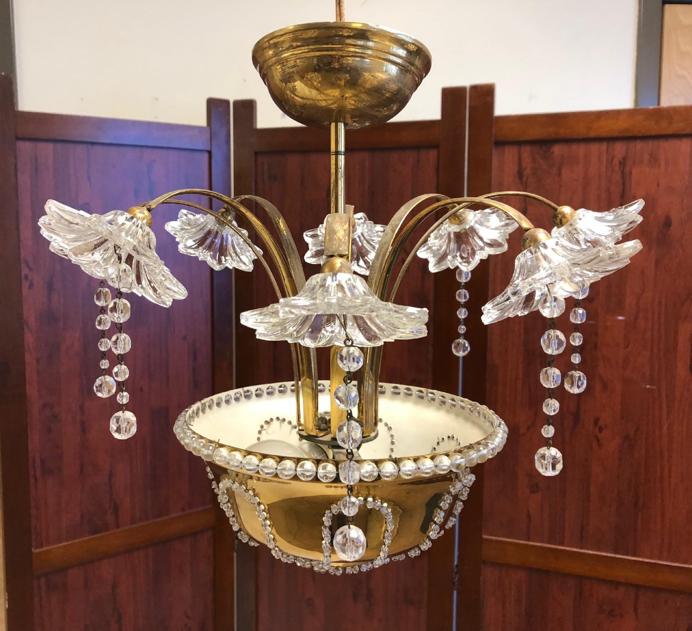 Italian Murano glass and brass chandelier. Has floral glass lights with prisms which illuminates at the base. Style of Paavo Tynell.
 