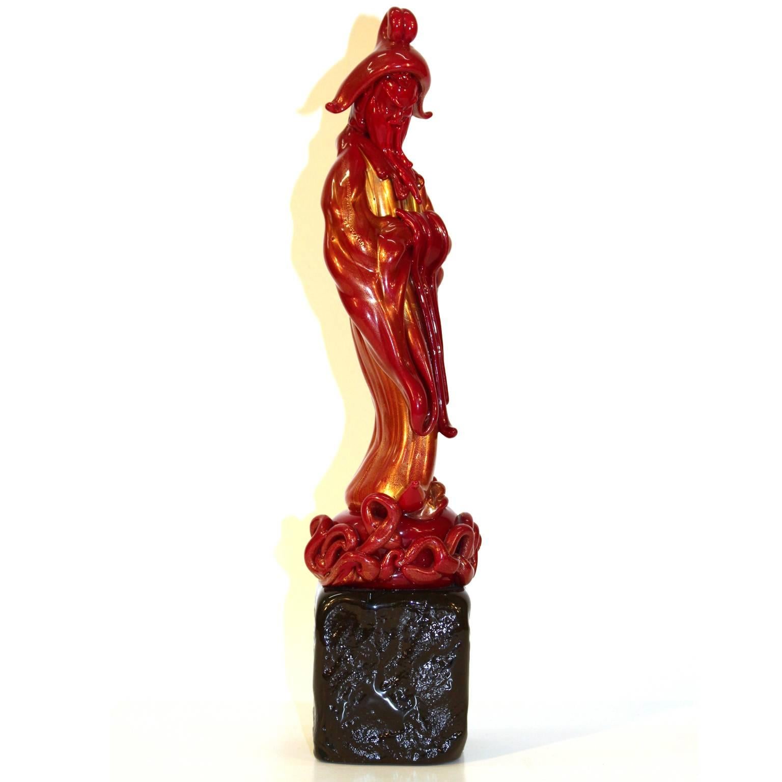 An Italian 1940s Murano art glass figure of a Chinese wise man. Blown red glass with 24-karat gold. The piece is in excellent condition.
