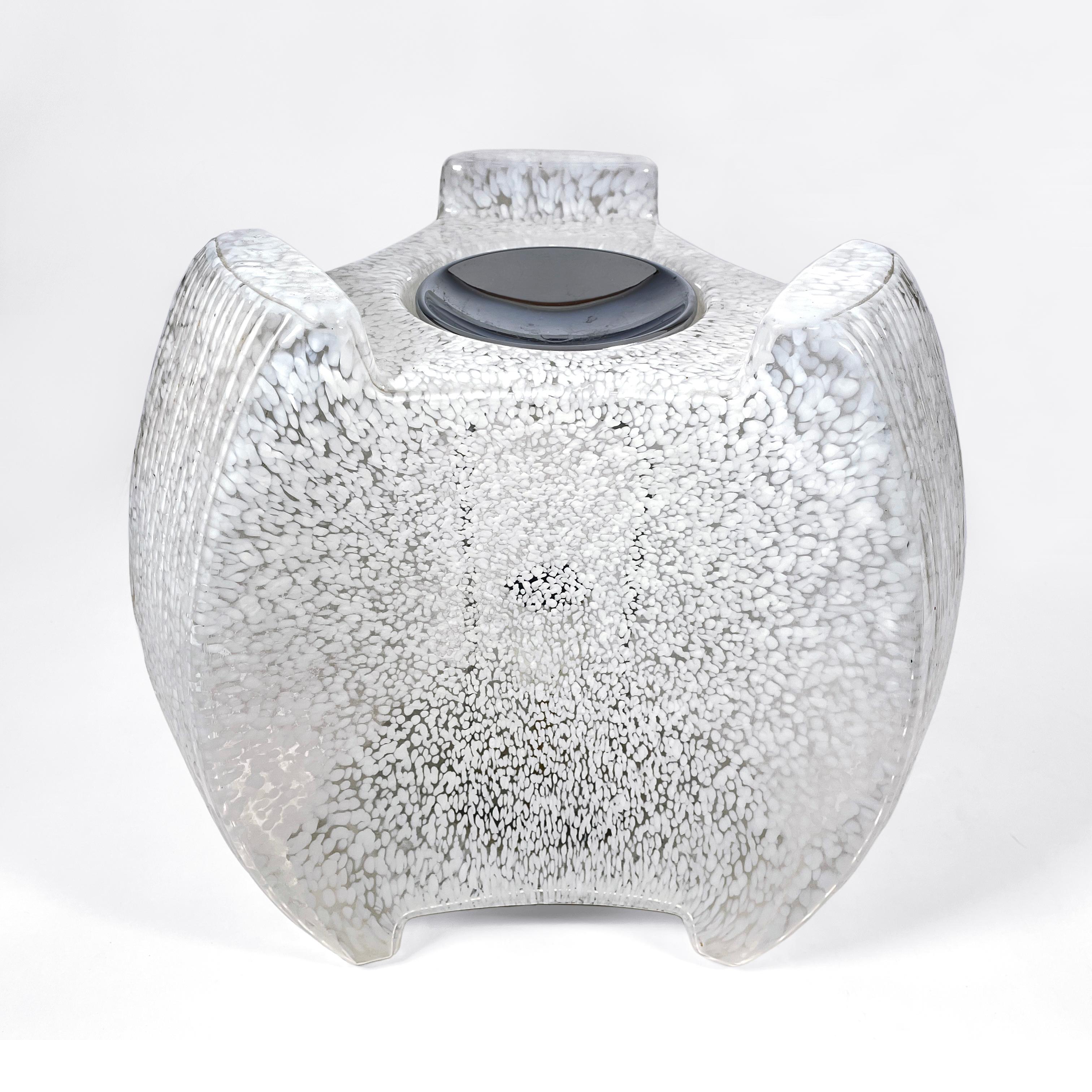 Beautiful italian 1970s table light in Murano glass. Clear glass with opaline white staining throughout and chrome hardware. 
Its curved and elegant shape harmonizes perfectly with the peculiar opaline staining of the Murano glass and make it a