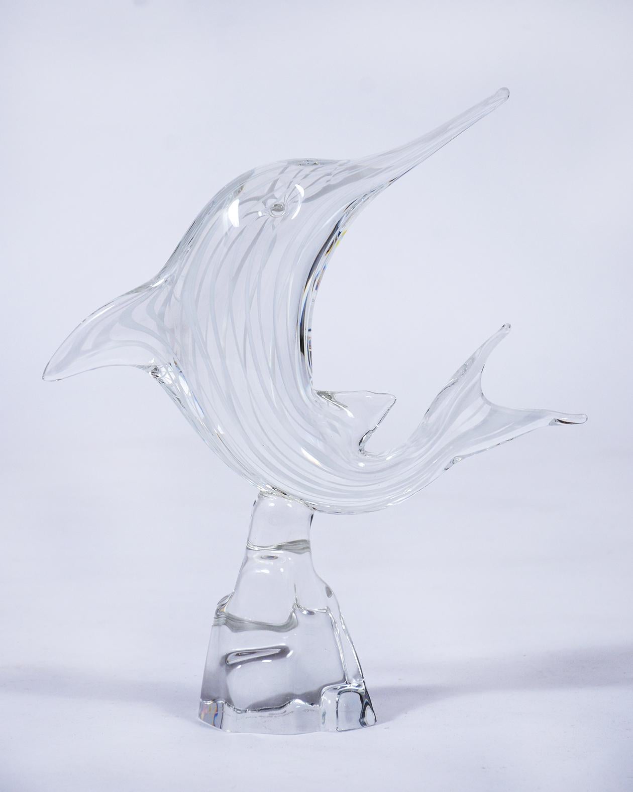 This beautiful Italian Murano glass dolphin is handcrafted, features a white streak design, and is in great condition. This vintage hand blown glass sculpture is ready to be displayed in your home or office space for years to come.