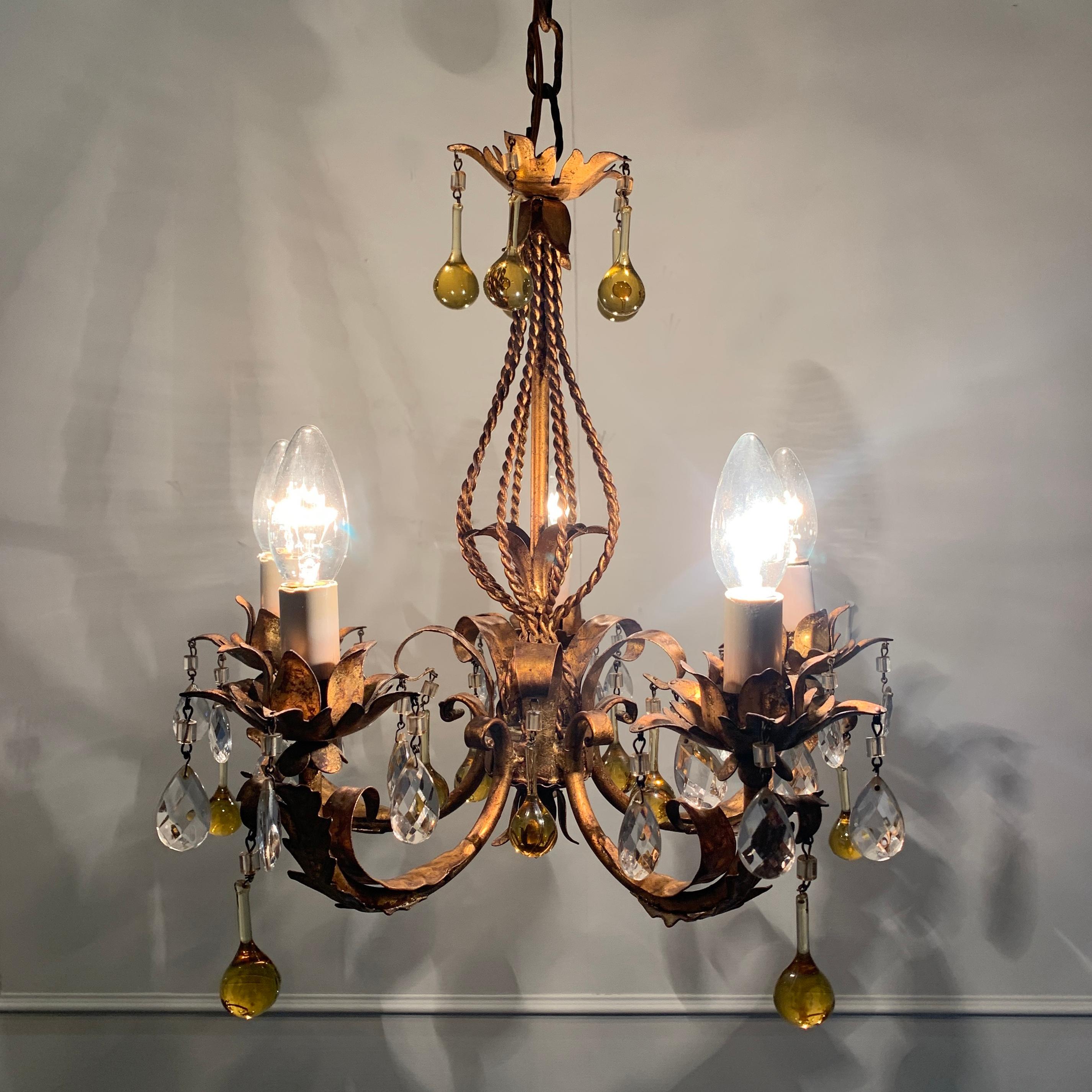 Italian Murano glass drop gilt chandelier
Italy, circa 1960s
Gilt leaves decorate the gilt rope detail central column
Large hanging hand blown golden Murano glass droplets are hung from the lampholders and top crown of the light
Smaller faceted