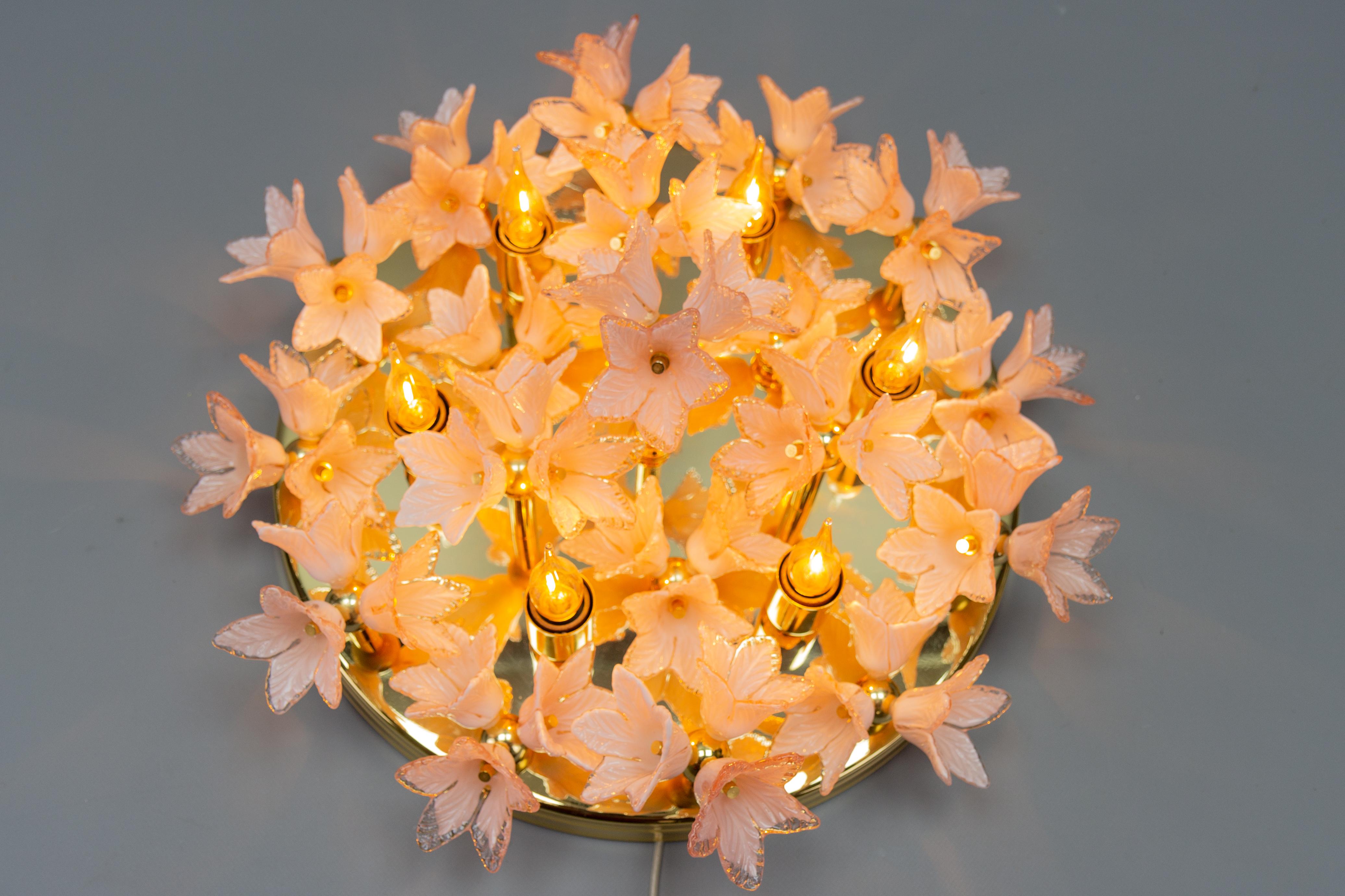 Italian Murano glass light pastel pink flowers and brass flush mount chandelier, circa the 1970s.
This stunning and large Murano glass six-light flush mount features 57 hand-crafted light pastel flowers, arranged in 19 bouquets of three mounted on a