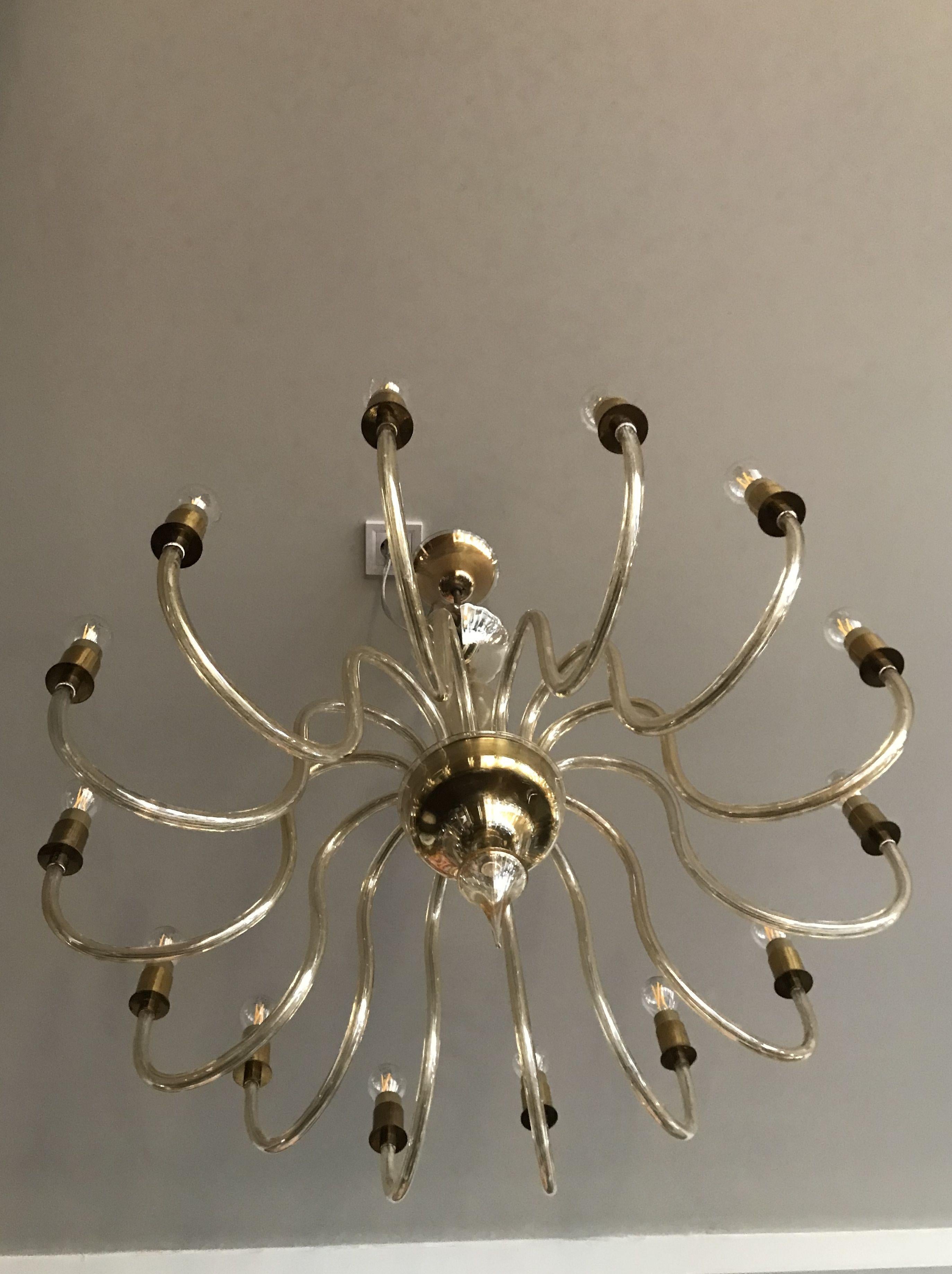 Wonderful glass arm chandelier with clear elegant shape and gold iridescent parts from Italy, Murano, midcentury period.