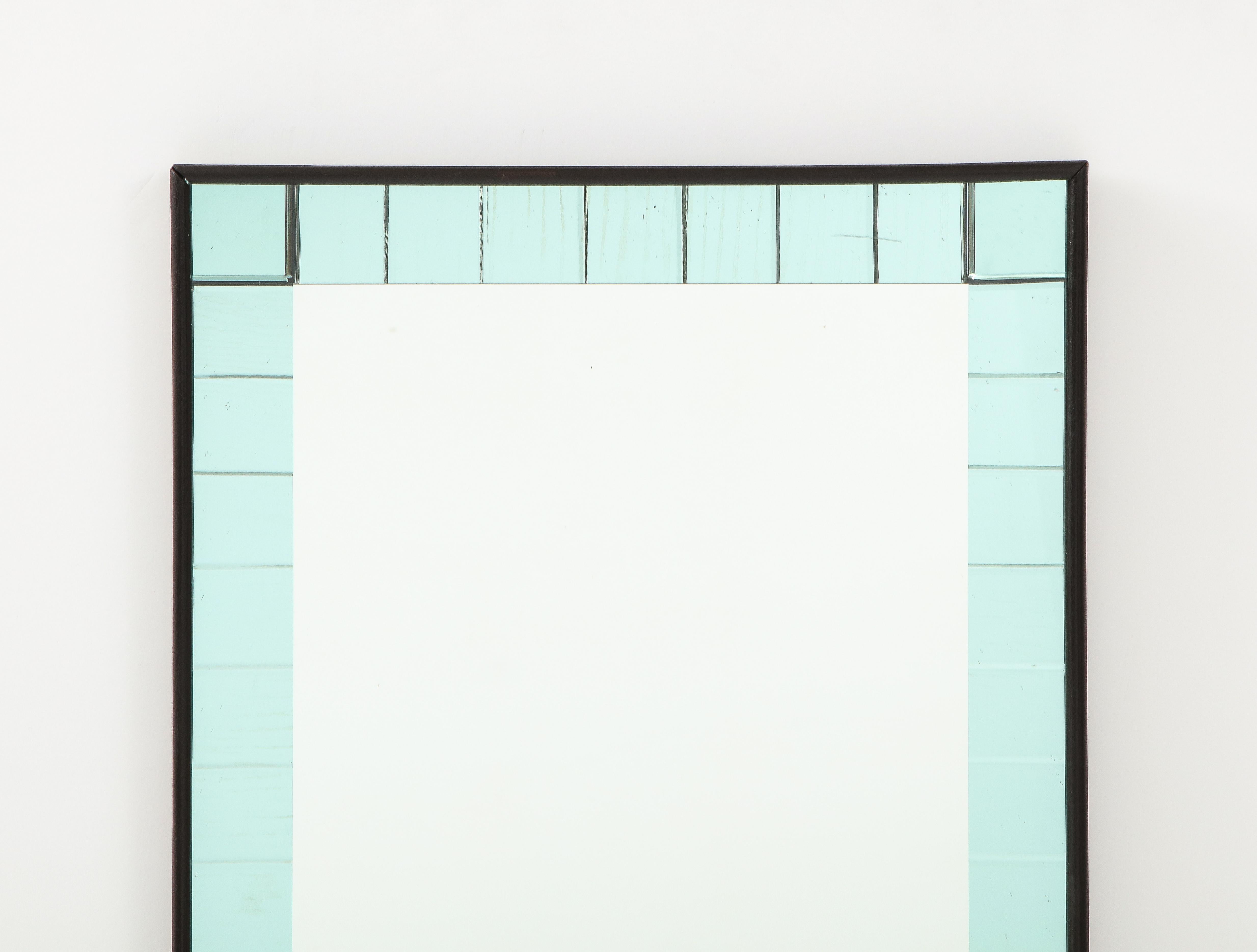An Italian Murano green/blue glass mirror; the rectangular center with clear glass bordered with square interior colored beautiful green/blue glass, the whole supported with a painted black frame. 
Murano, Italy, circa 1950s 
Size: 44
