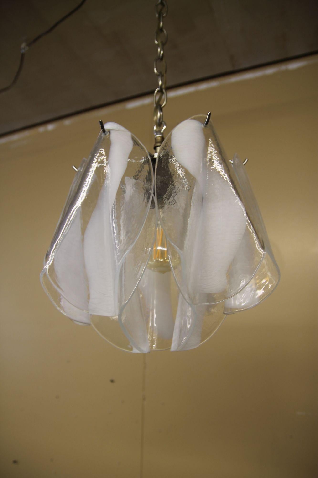 Great small scale murano glass pendant. This clear and milk glass light looks great either when its lighted or light is turned off.  Will be great in a hall with or over a small table. The light has a nickel frame with 9 of the prisms.
