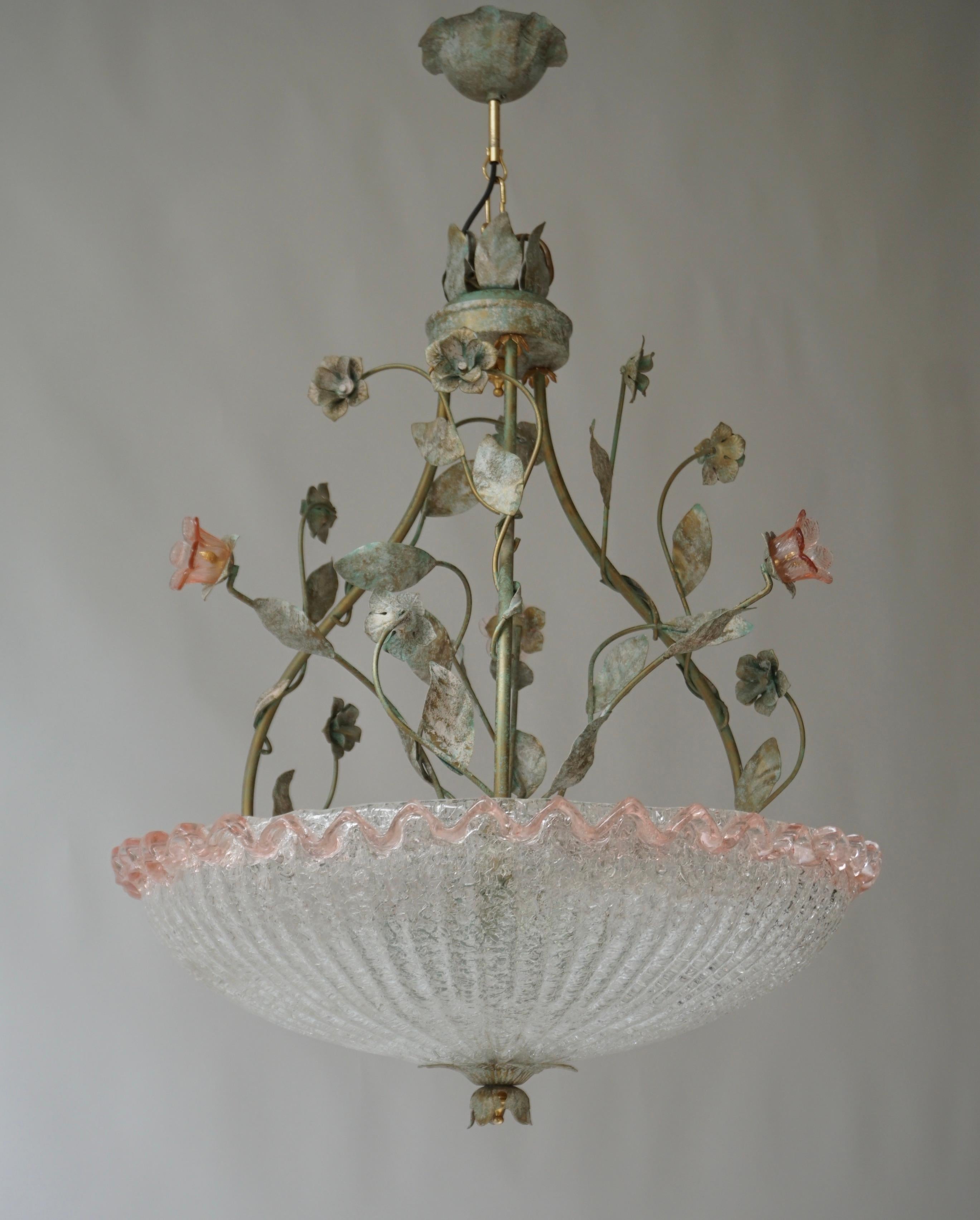 Elegant Italian glass chandelier with three pink glass flowers and patinated green colored frame

A large Hollywood Regency chandelier from Italy manufactured in the 1970s. The chandelier has three sockets for incandescent lamps with screw base or