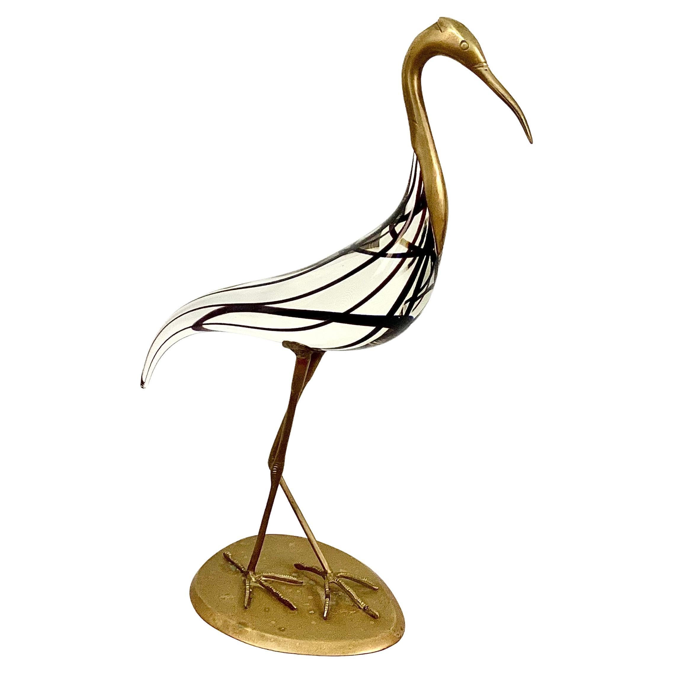 Impressive 20th century Italian Murano Glass Sculpture Of A Heron, attributed to designer Luca Bojola for Lico Zanetti, Florence, Italy. Sculpture features heavy solid glass bird with black threads. Bird's face neck, beak, legs and feet are brass,