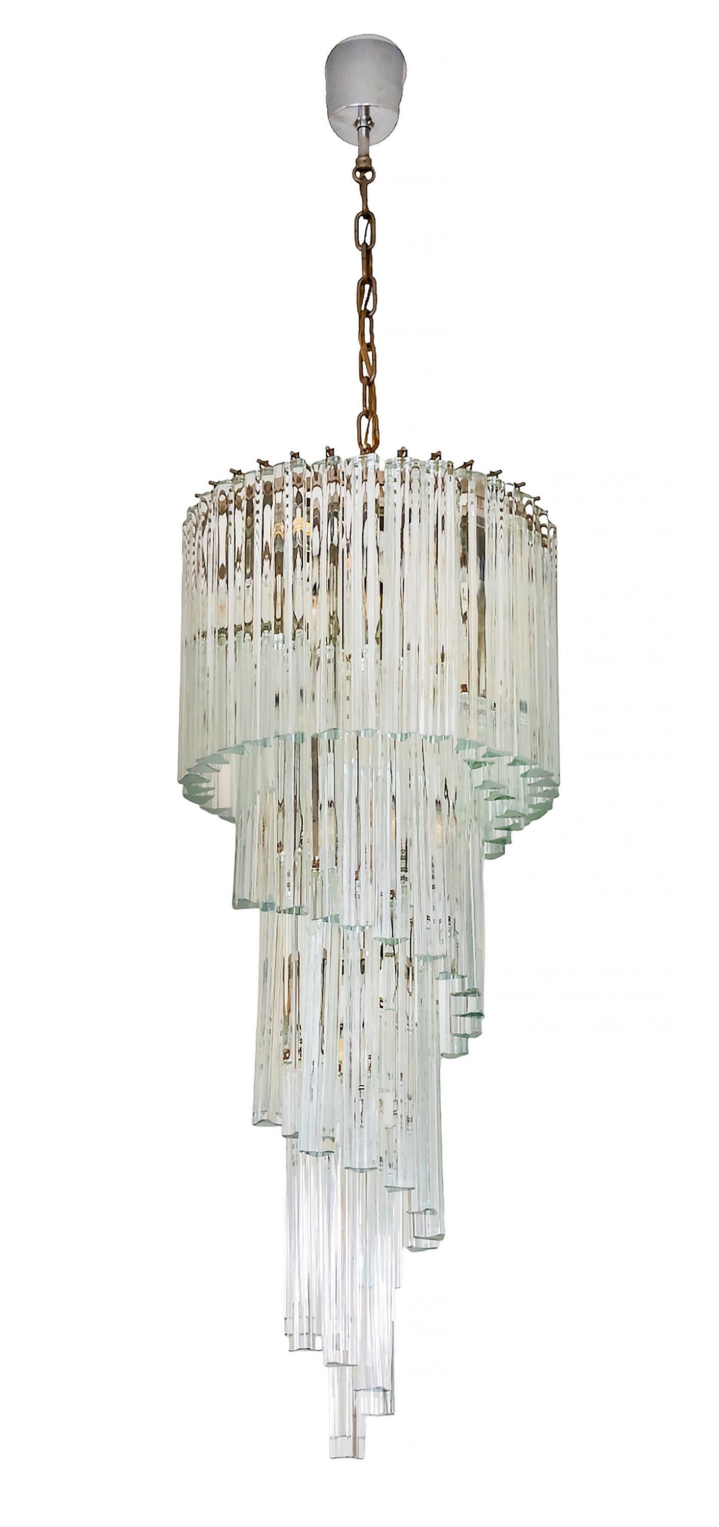 Italian chandelier is made of solid clear Murano glass.
The design is spiral form with triangular glass details mounted on metal framework.
It is very heavy.
Total height: 152 cm
Height without chain: 100 cm
Diameter: 40 cm
Very good vintage