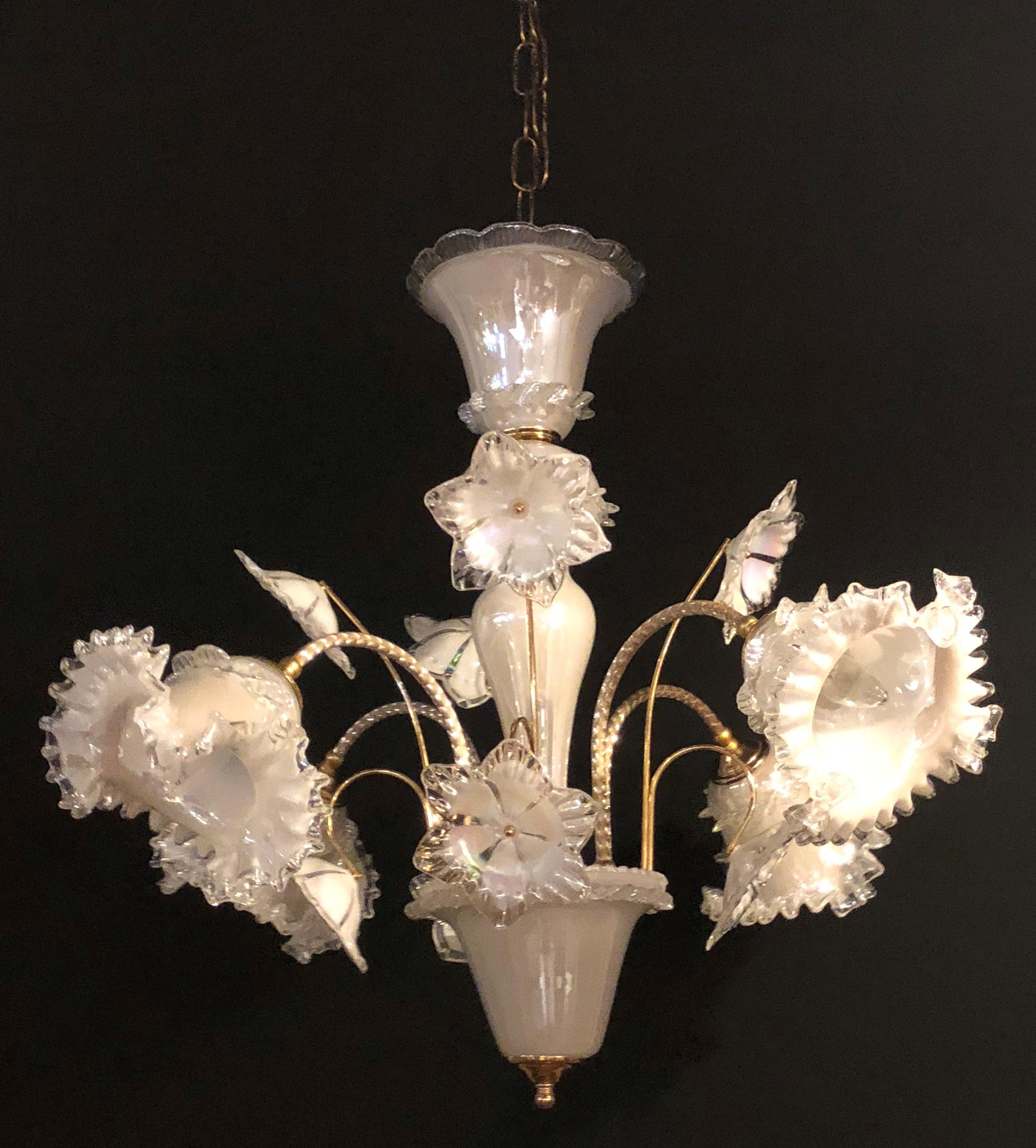 An Italian Murano glass tulip form chandelier. We have three of these fine chandeliers in different colors. The lower pot or vase base having a stem flowing from the bottom with sprouting arms terminating in tulip forms each taking a single light
