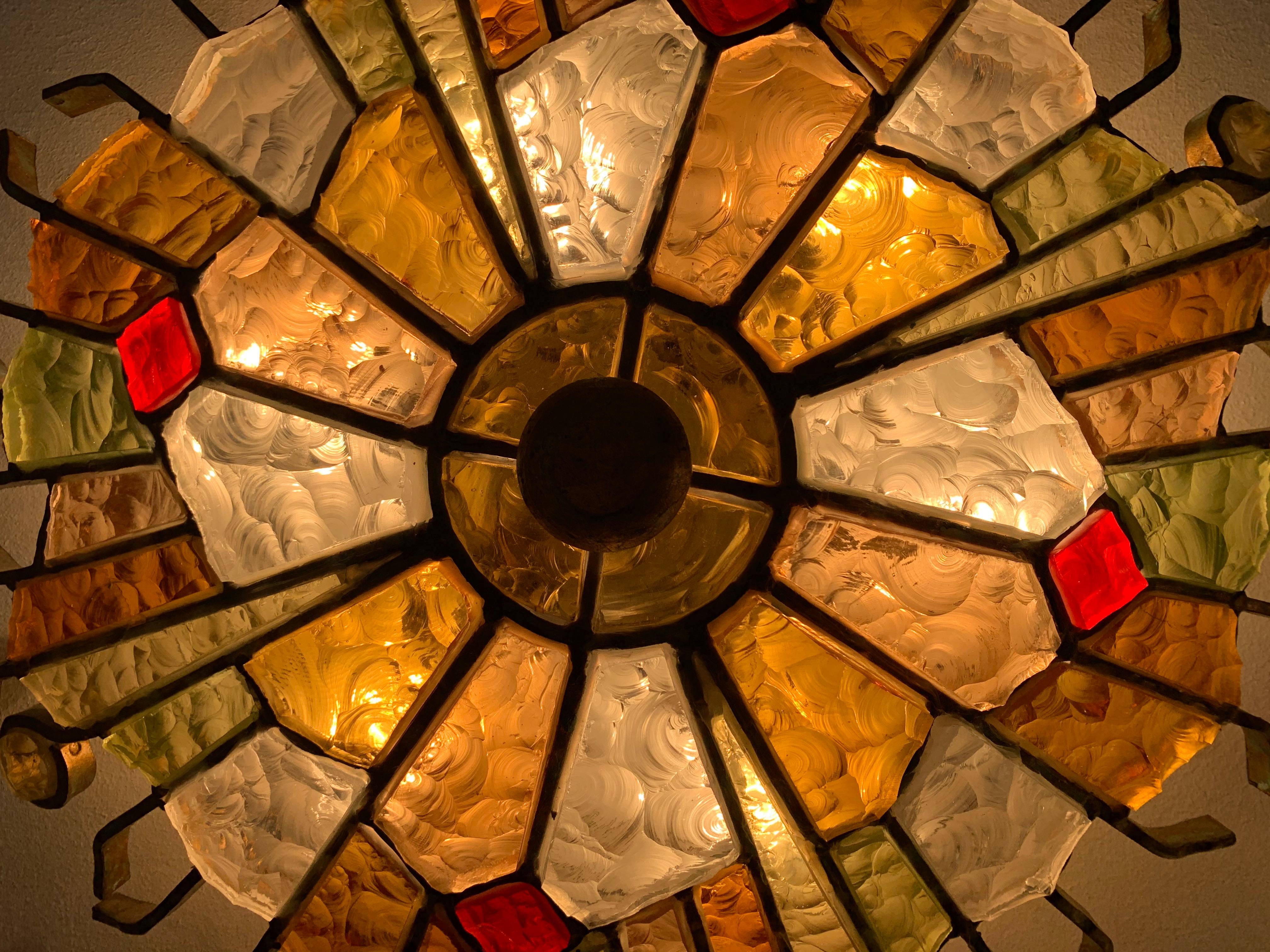 Murano glass wall lamp designed and manufactured by Longobard in 1970. The structure is in hand-worked golden wrought iron with the insertion of thick colored hammered glass.
 
  
   