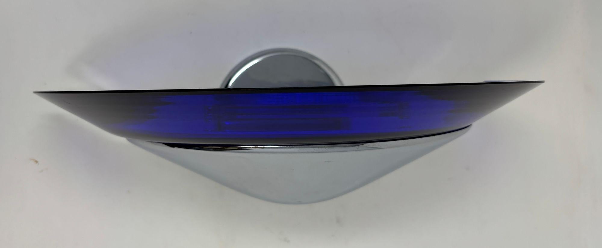 Italy Vetri Di Murano Post Modern style wall light attributed to Mauro Marzollo for Itre Italia.
Wall sconce light with a  Murano blue glass diffuser on chrome metal mounting.
These beautiful half  moon shape wall sconce lamps feature beautiful