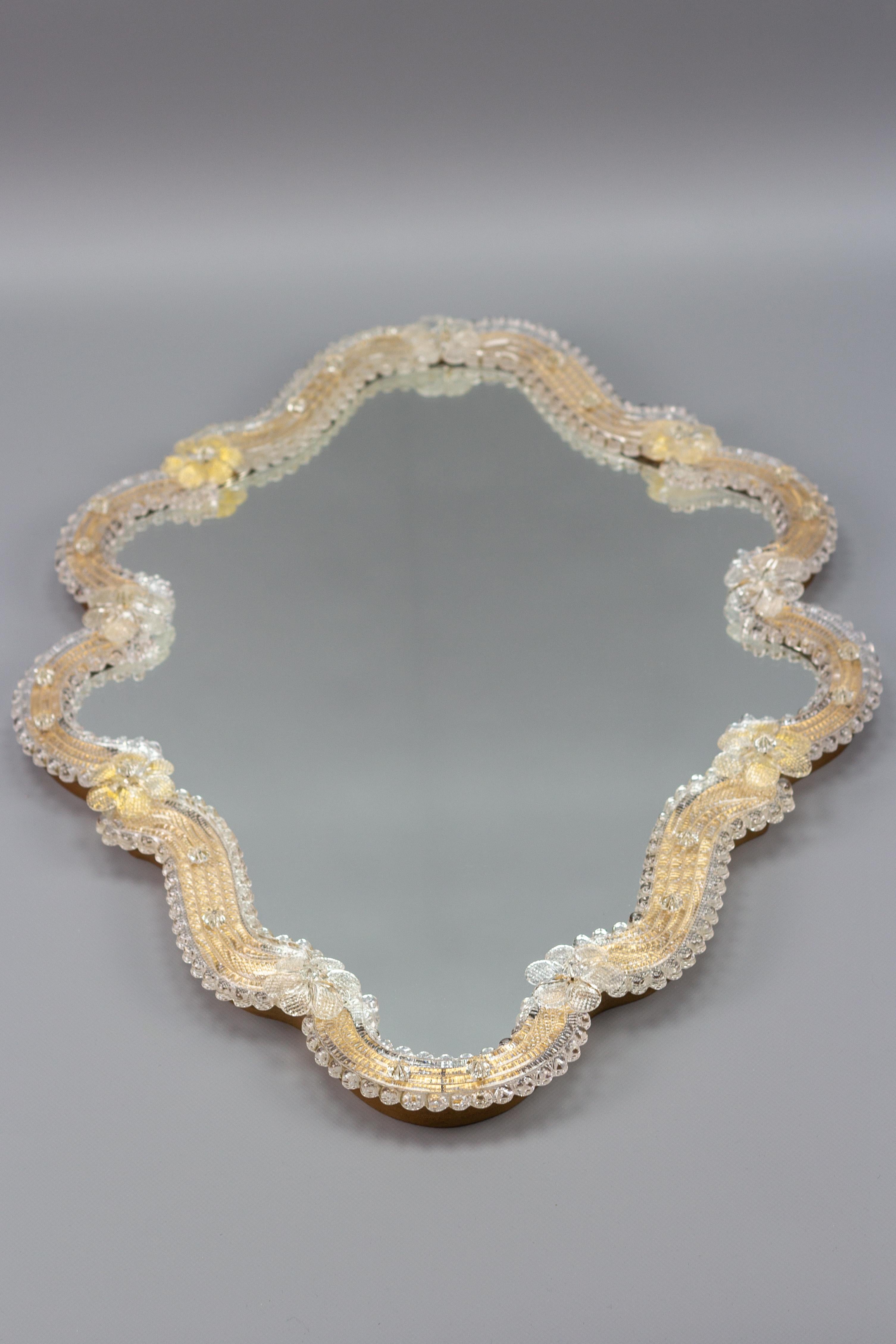 Beautifully shaped Italian mirror in the style of Venetian mirrors in transparent and light golden Murano glass. Adorned with nine handmade glass roses - five made of clear glass and four of lightly golden glass.
Dimensions: height: 62.5 cm / 24.6