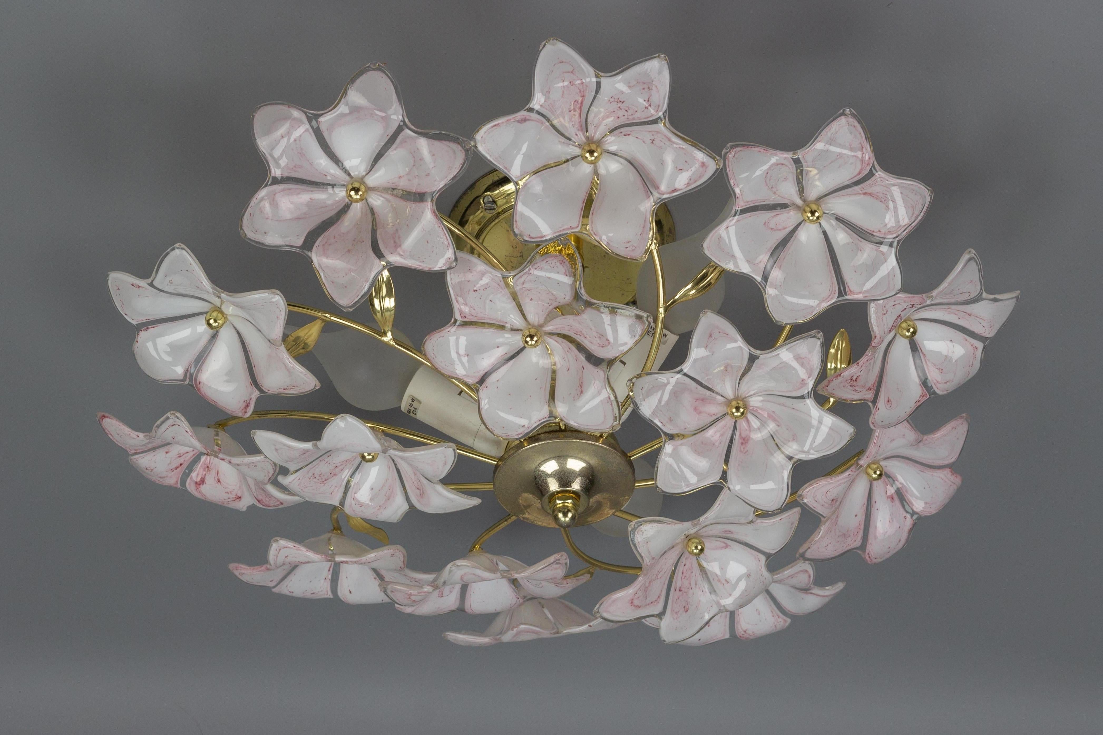 Adorable three-light ceiling light or chandelier with fifteen white and pink glass flowers. Each beautiful Murano glass flower is hand blown and therefore all fifteen are slightly different.
Three sockets for E14 size light bulbs.
Dimensions:
