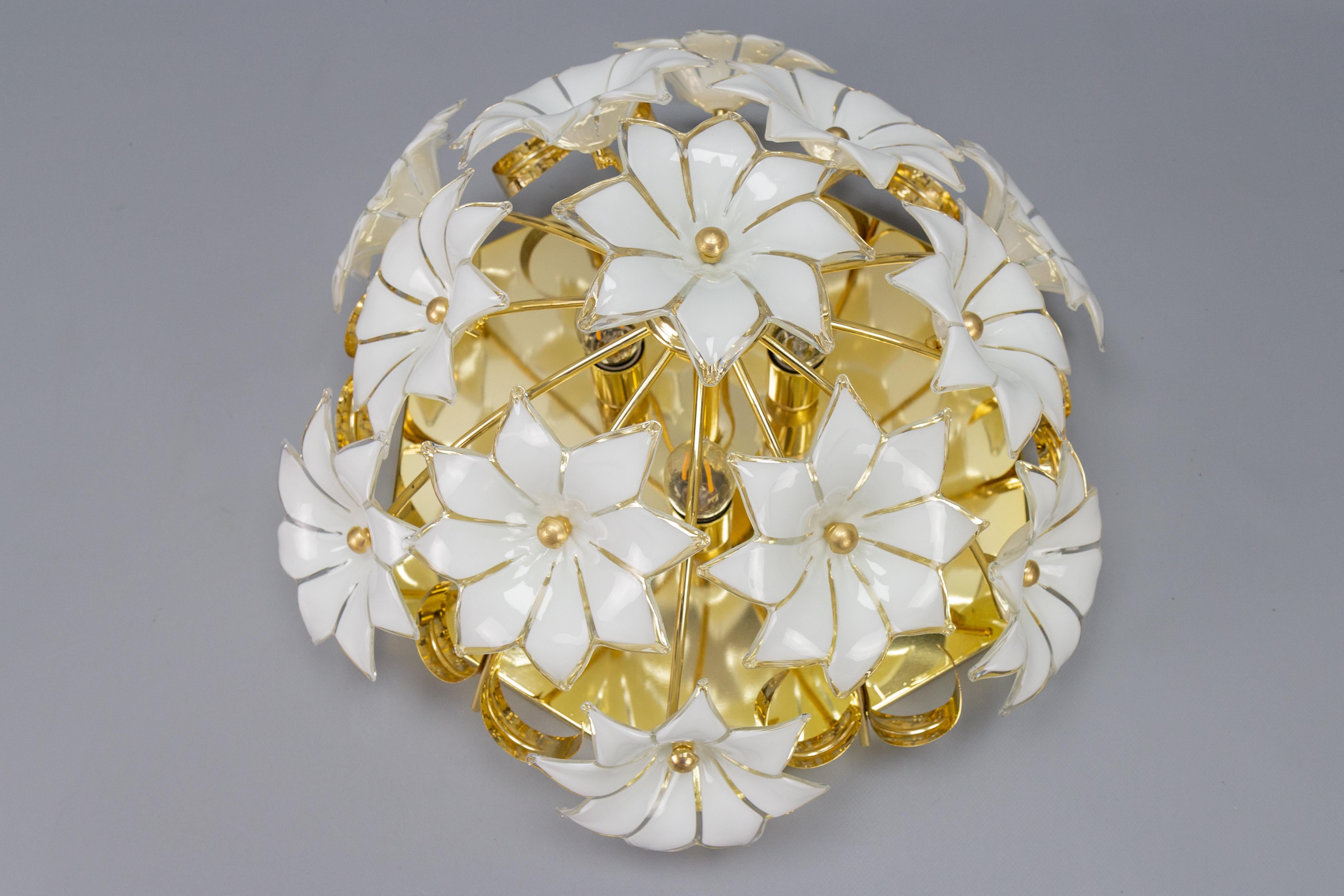 Adorable Italian three-light flush mount or ceiling light with twelve white and clear glass flowers from circa the 1970s. Each beautiful Murano glass flower is hand blown and therefore all twelve are slightly different. This ceiling light fixture