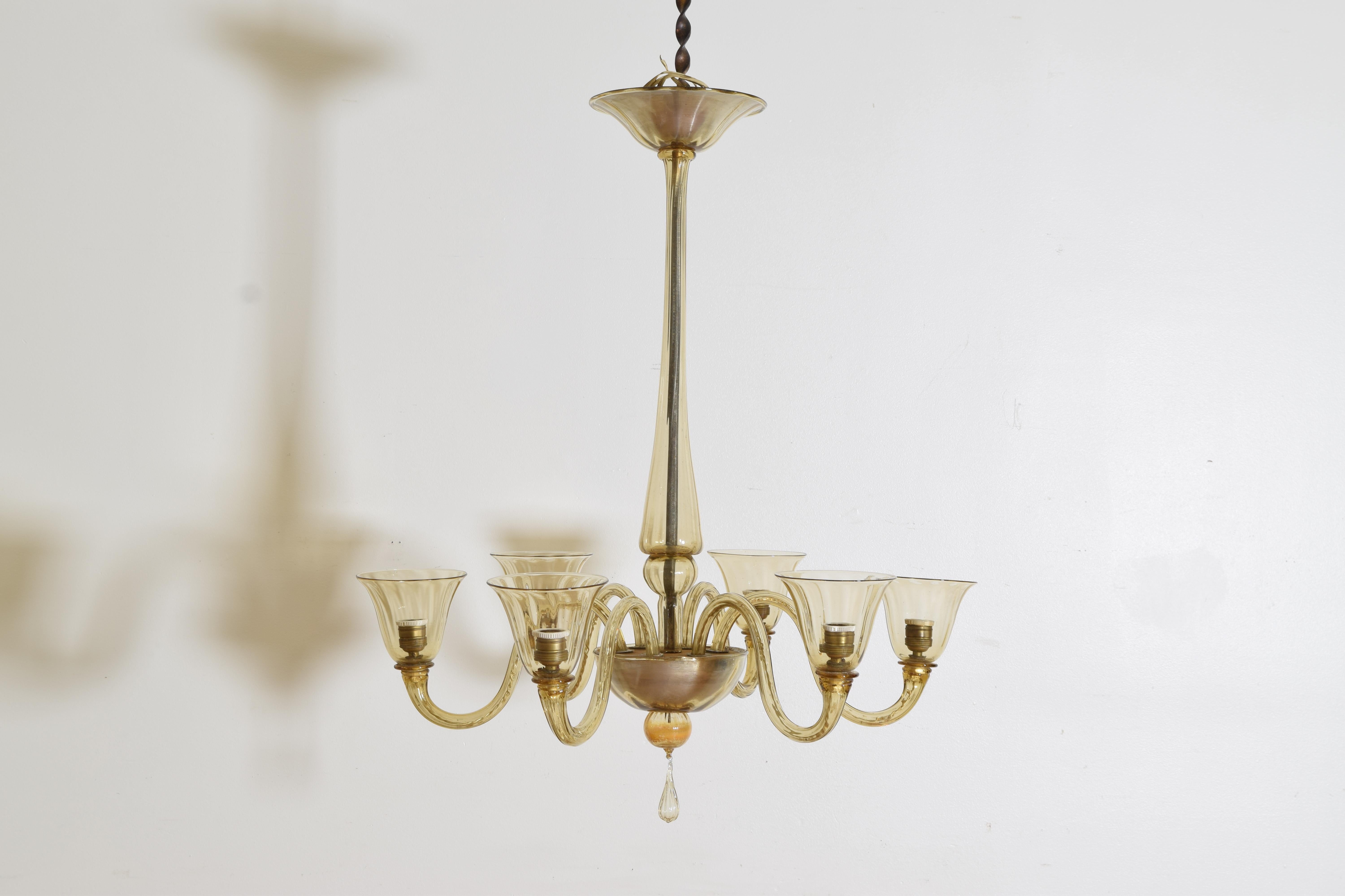 Constructed entirely of blown glass components with a canopy atop a straight standard, the center section issuing six curved arms with large bobeches/shades, the shaped bottom with a hanging glass tassel