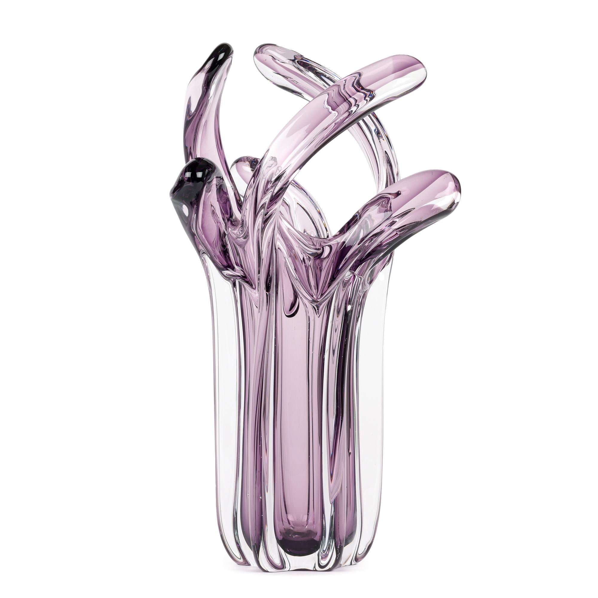 An incredible Italian mid-century stylized art glass vase with a tentacle or hand formed top made in Murano. The heavily made clear glass vase stands on a narrow round shaped base with vertical ribbing around the body extending like an arm to a