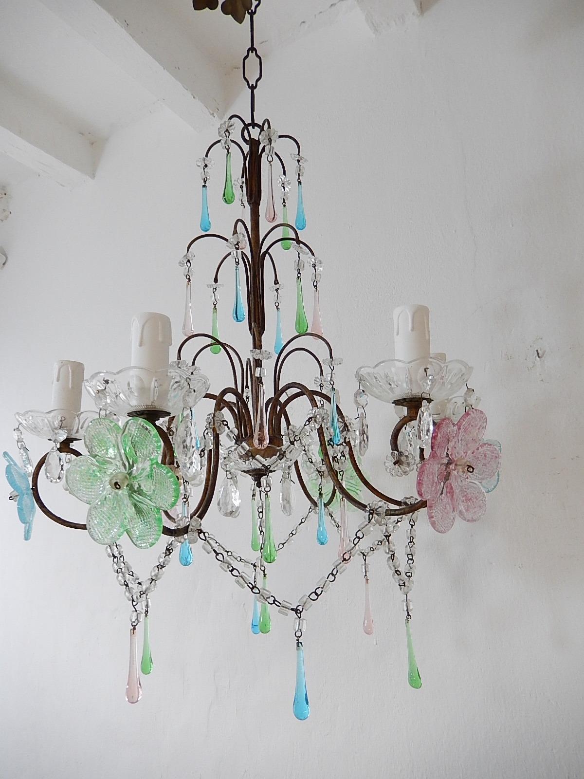 Housing 6 lights, sitting in crystal bobeches, dripping with crystal prisms. Will be rewired with certified US UL sockets for the UA and appropriate sockets for all other countries and ready to hang. Macaroni crystal swags throughout. Adorning pink,