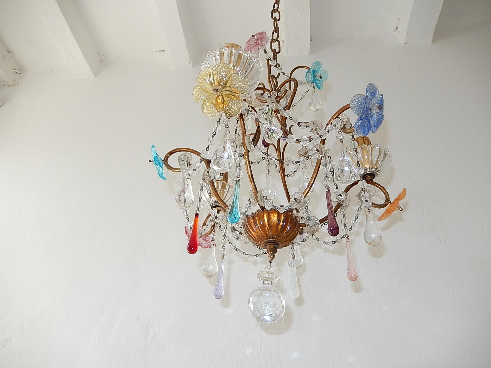 Housing 3-light, sitting in rare crystal bobeches. Will be rewired with appropriate sockets for country and ready to hang. Crystal ball swags throughout. Adorning pink, orange, yellow and blue Murano flowers colorful Murano drops to match. Adding 21