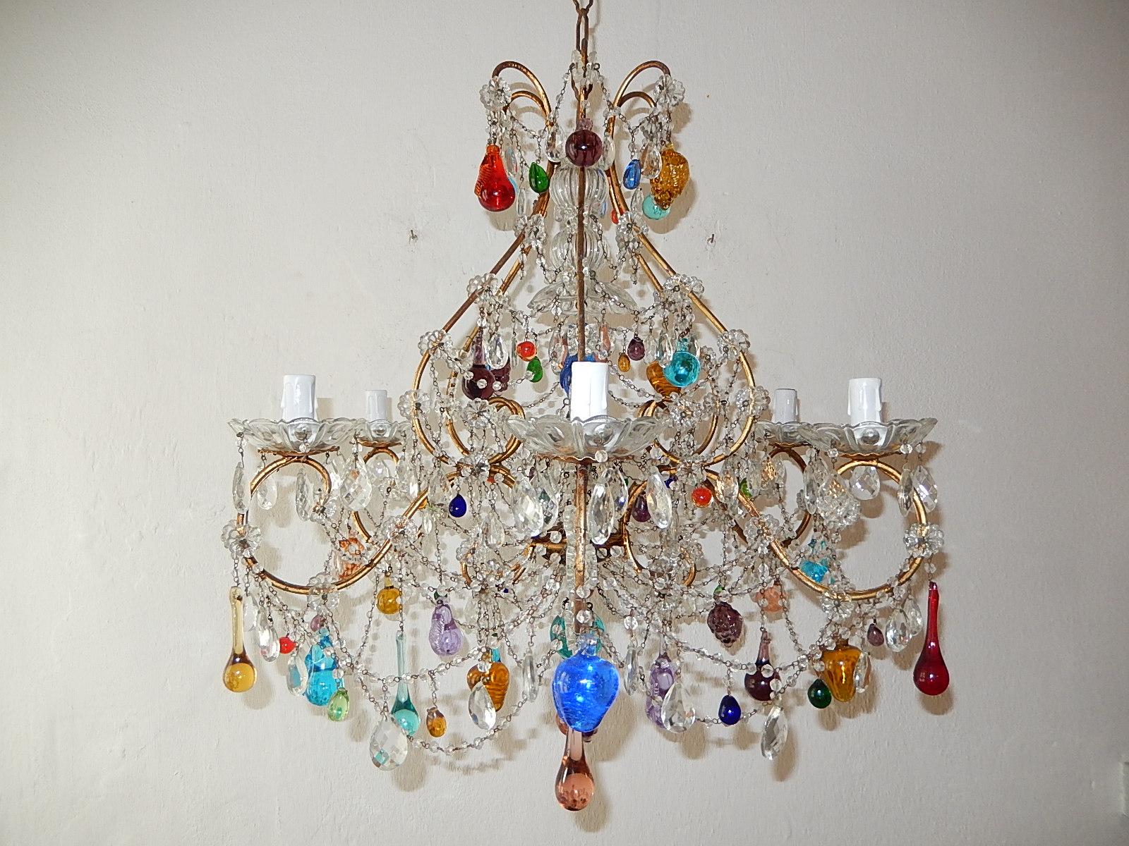 Housing six-lights, rewired and ready to hang. All lights sitting in crystal bobeches. Beaded swags throughout. (all hand tied) Adorning crystal florets, Murano fruit and drops in all shapes and colors. Blown Murano glass in centre top. Adding 12