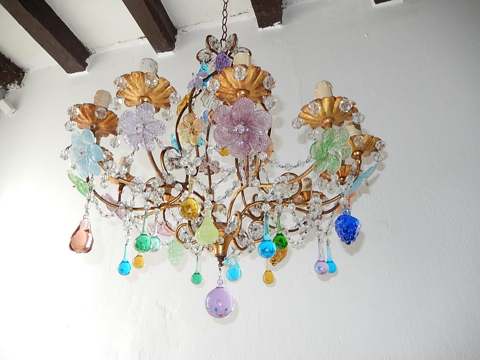 Housing 13-light, rewired and ready to hang. Beaded swags throughout. Adorning multicolored prism flowers, Murano fruit and drops in all shapes and colors. Huge lavender finial on bottom. Adding 10 inches of original chain and canopy. Free priority