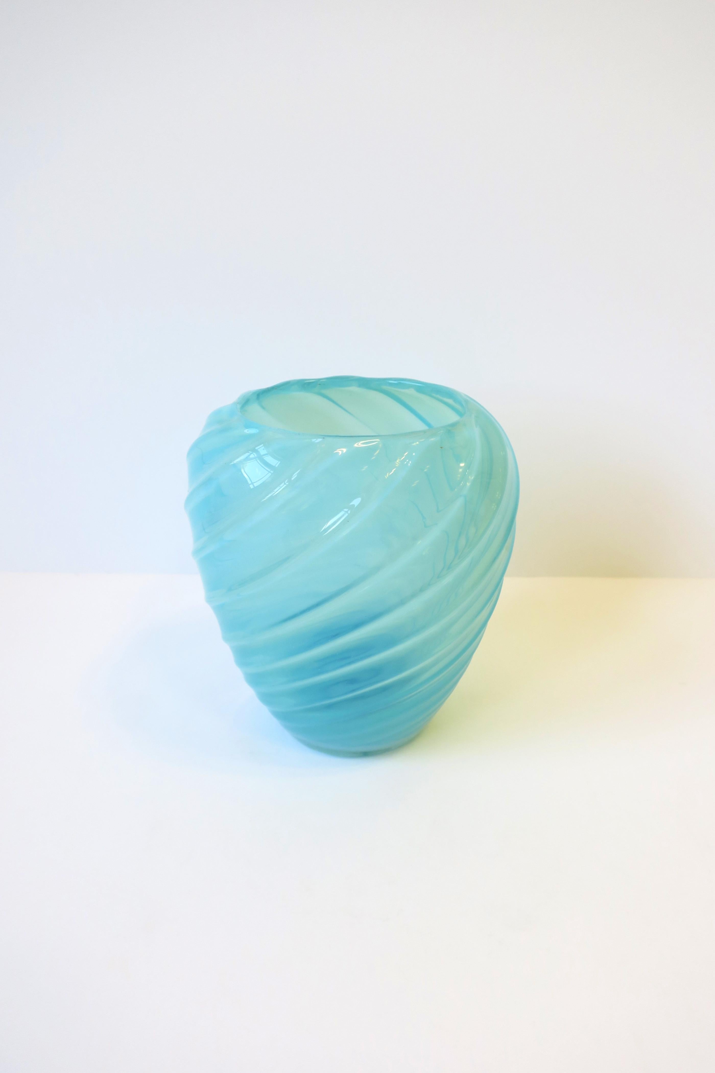 A very beautiful sky-blue opaline Italian Murano art glass vase in the style of Seguso, circa mid-20th century, 1960s, Italy. Vase is a sky blue opaline hue with a twisted fluted design. Beautiful with or without flowers (as shown.)

Dimensions:
