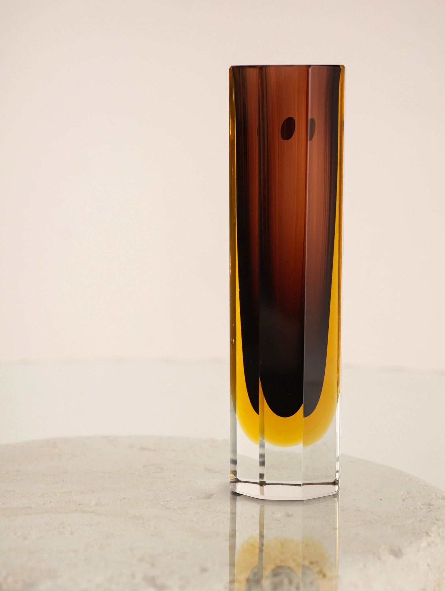 Mid century Murano sommerso glass vase. Cut facets show inner garnet and yellow colors. Retains original manufacturer sticker. Neck opening measures 2.25”.

Sommerso is the glassmaking technique of creating two or more layers of contrasting glass