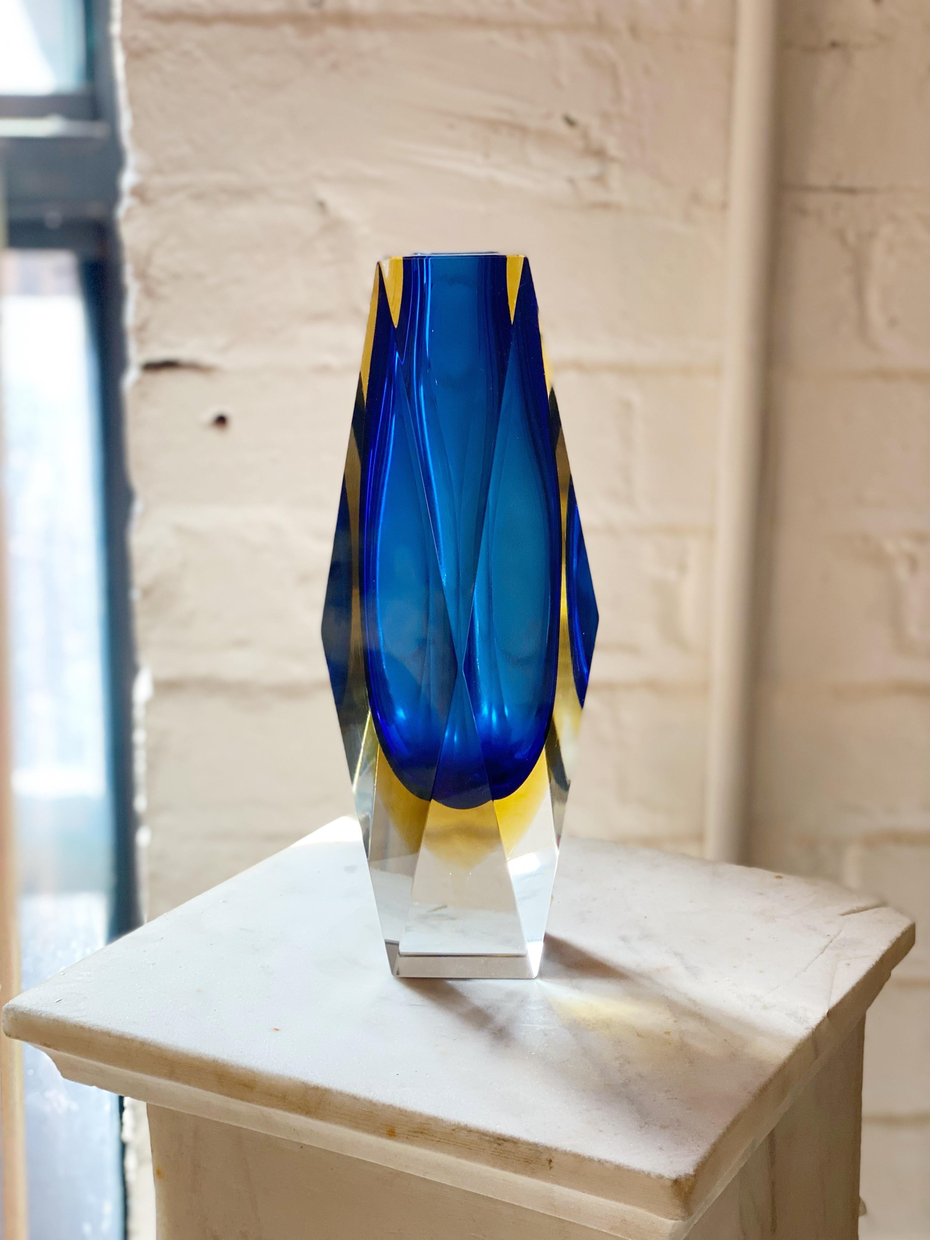 Mid Century Murano sommerso glass vase by Casa del Regalo Bortoli, Venezia. Cut facets show inner cobalt and yellow colors. Retains original manufacturer sticker. Neck opening measures 1”.

Sommerso is the glassmaking technique of creating two or