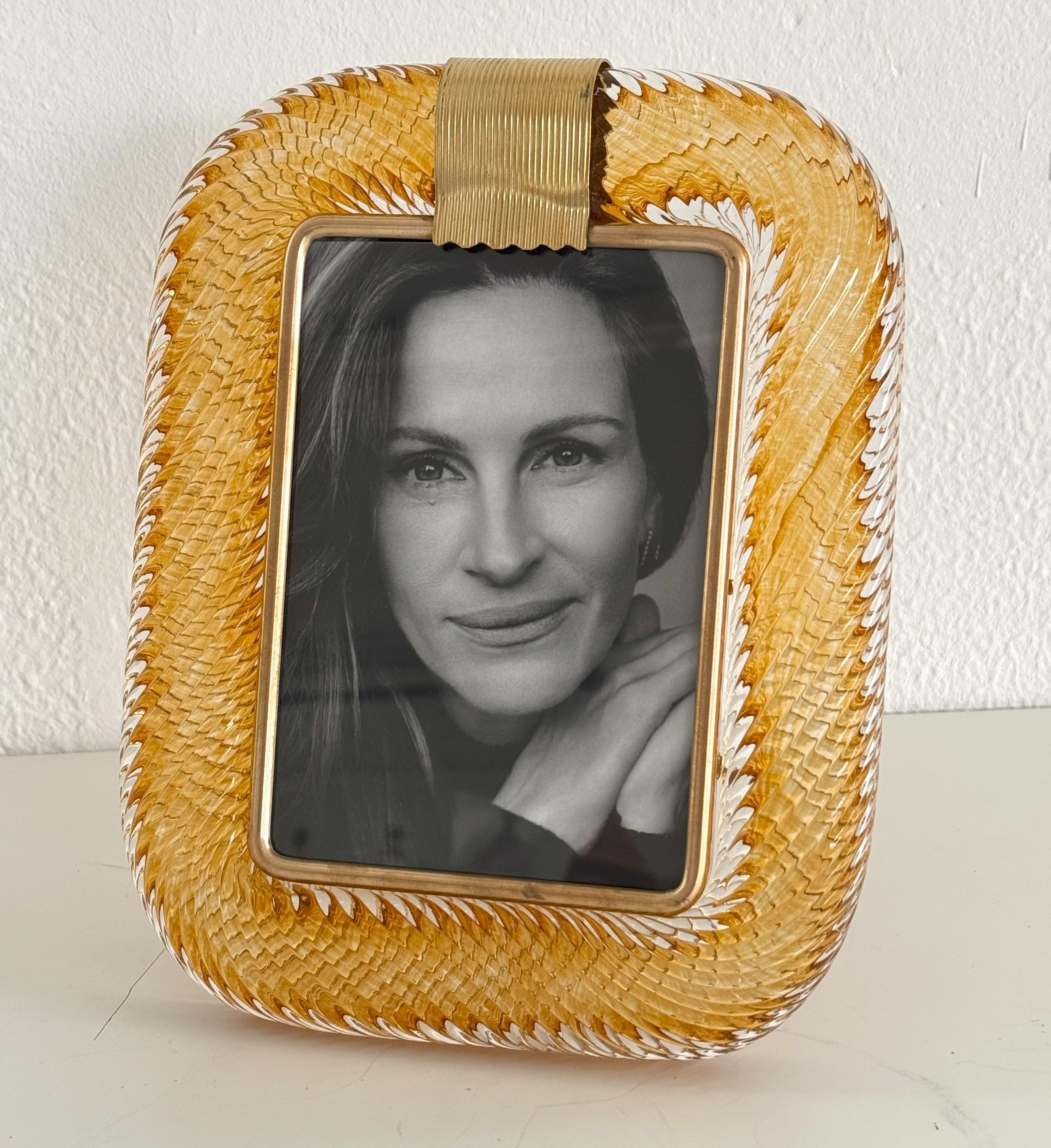Italian Murano Twist Glass Picture Frame in Barovier Toso Style

Italian Modern Murano twist glass and brass picture frame, in amber / golden color.
Suits for 5x7