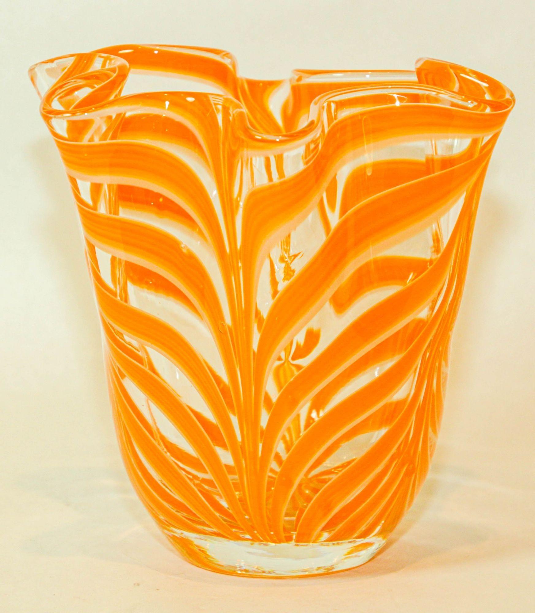 Beautiful Italian Murano Venetian style hand blown orange art glass decorative handkerchief vase.
Sculptural decorative bowl in an organic form with orange and white swirl on clear glass.
Beautiful decorative studio art glass piece for any table or