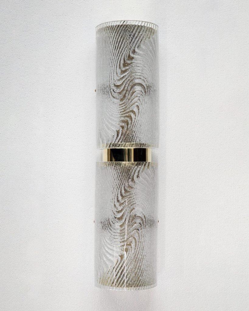 Italian Murano Wall Sconces made by eModerno, meticulously created in Italy to meet the highest standards of quality.
The gracefully curved clear and white glass, mimicking the 'Corteccia' or 'tree bark' aesthetic, is artfully secured by a polished