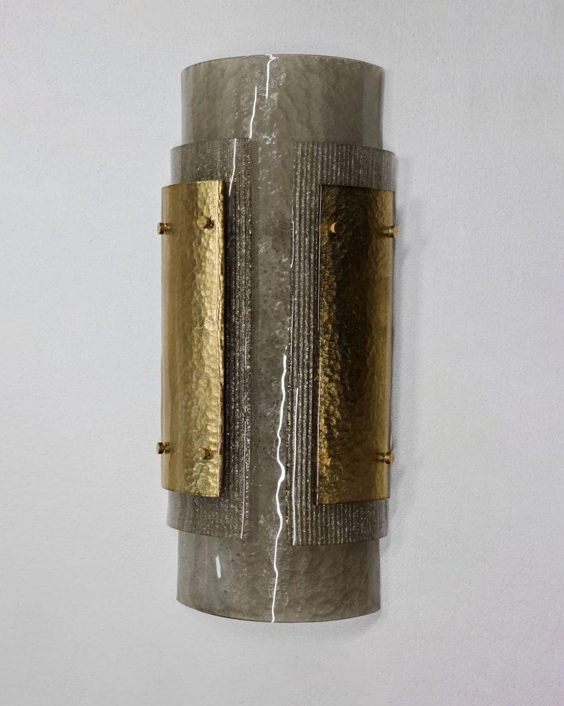 Italian Murano Wall Sconces made by eModerno, meticulously created in Italy to meet the highest standards of quality.
These large Italian wall sconces, with three layers of gold, and smoke coloured glass.
Made by hand in Venice, each sconce is