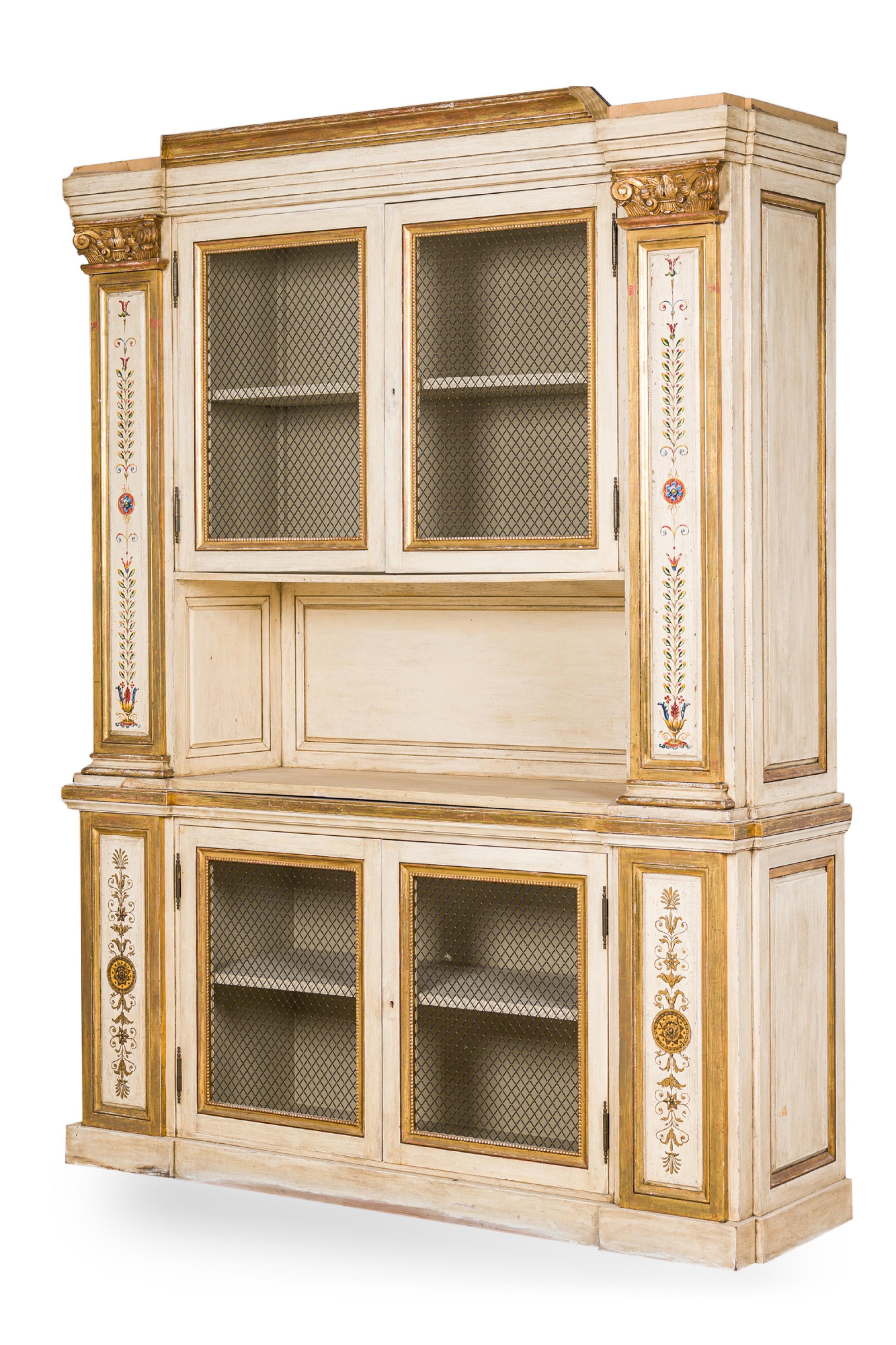 Italian Neo-Classic monumental off-white painted and gilt trimmed breakfront / bookcase having 2 upper and 2 lower doors with a wire mesh centering a recessed platform with column form decorated sides and carved capitals
 

 Condition: Good; Minor
