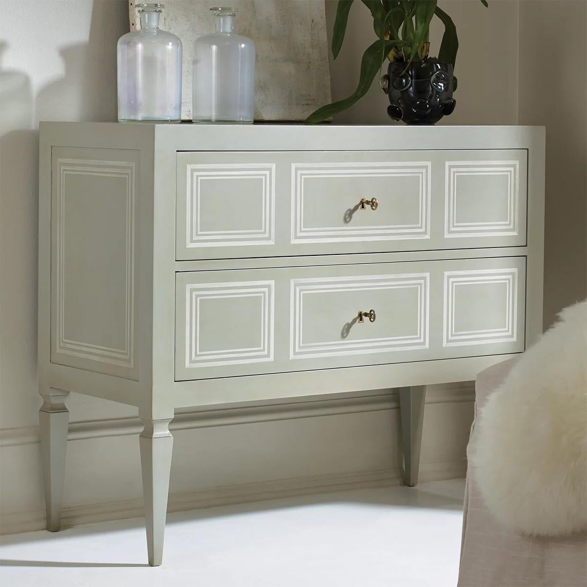 Northern Italian Neo Classic Painted Commode with a grey painted finish and ivory accents, this hand-painted two drawer commode has a simple modern look and roots in Northern Italy in the 19th century.
Two long drawers with antique key pulls raised
