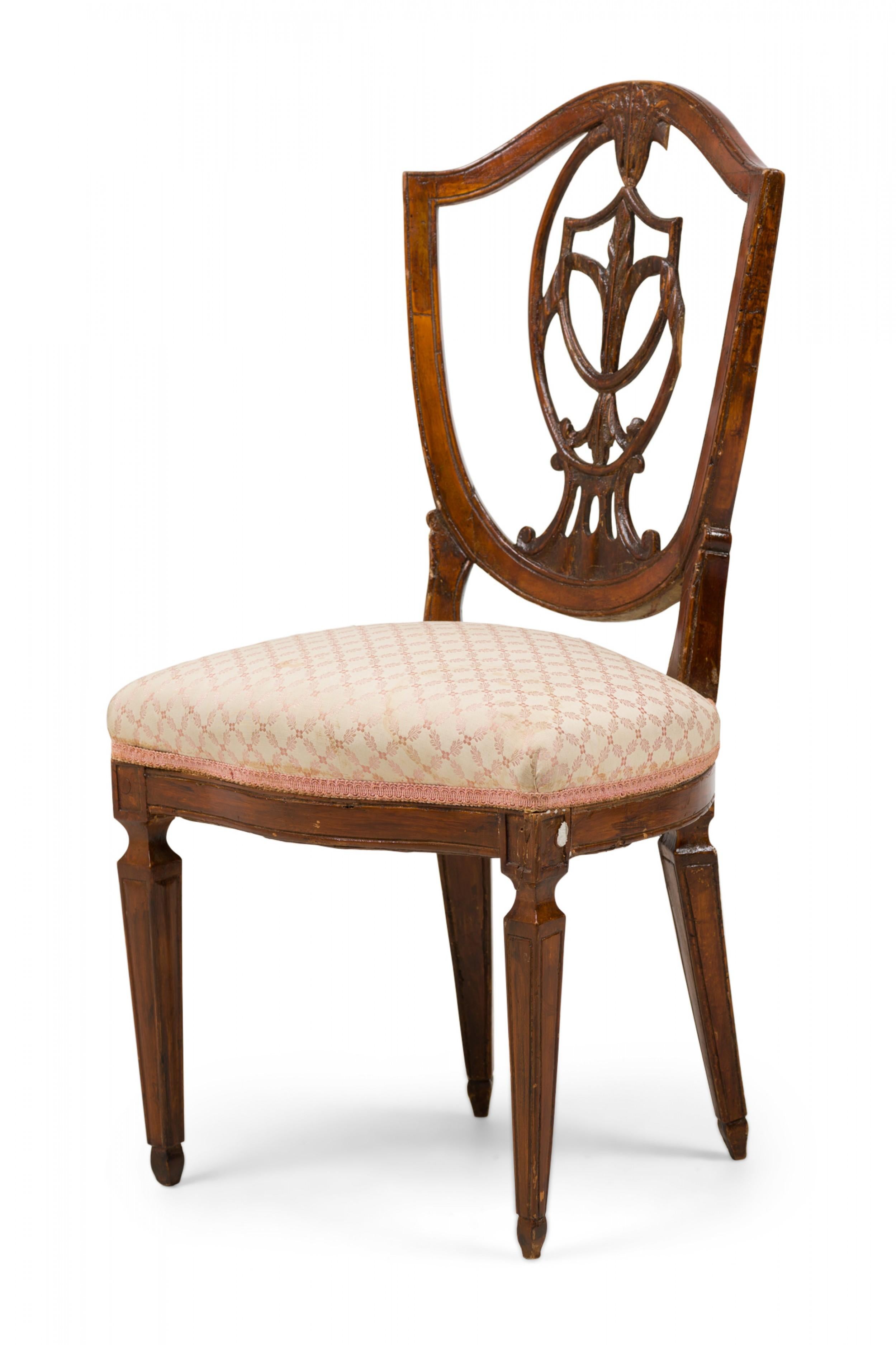 Italian Neo-Classic side chair with an openwork shield form back, carved decorative splat, padded seat upholstered in floral patterned beige fabric with embroidered trim, and 4 shaped legs with incised highlights tapering down to spade feet.