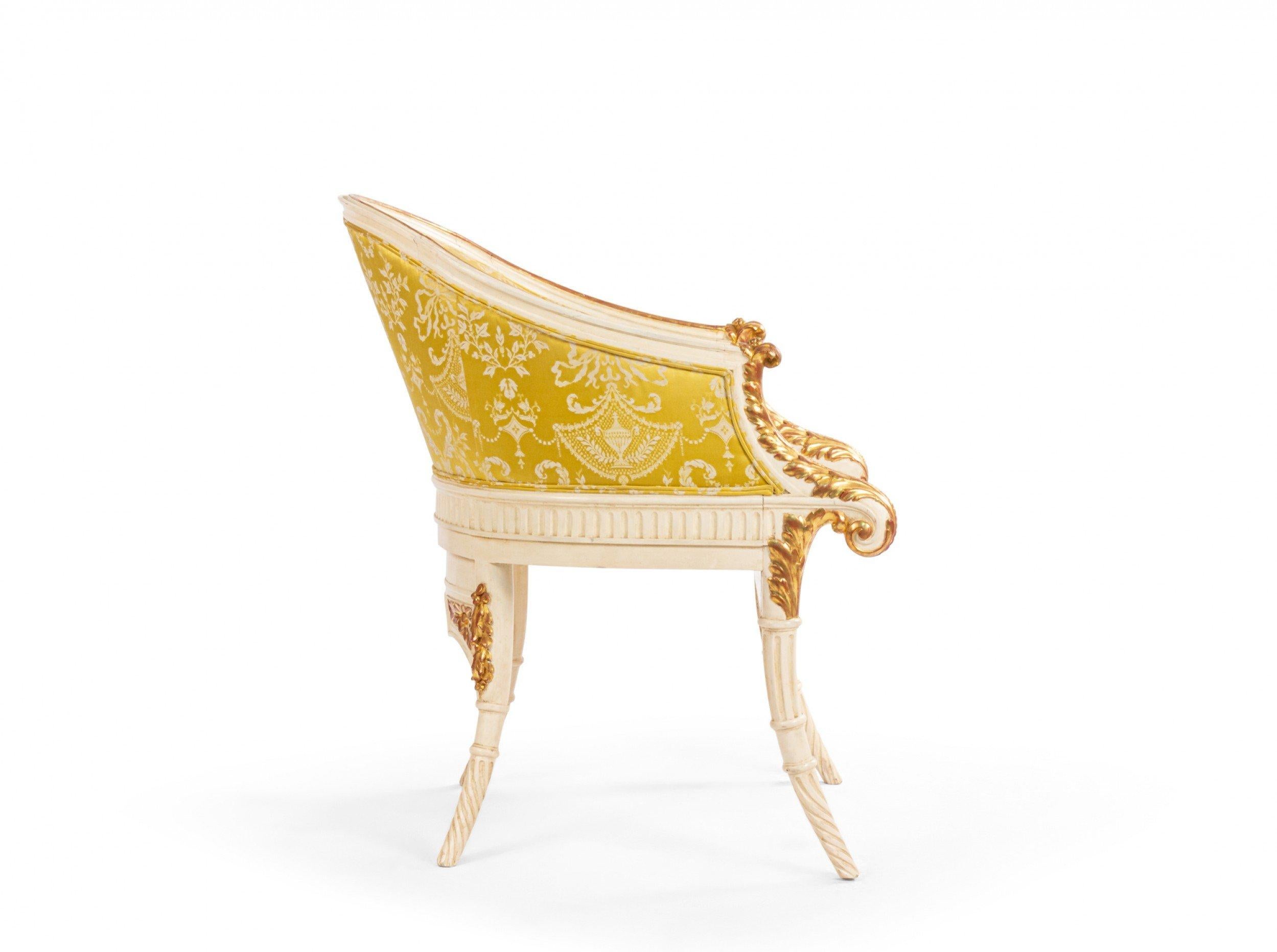 Italian neo-classic style 19th Century white and gold painted round back carved arm chair with front scroll design and gold damask upholstery.
 