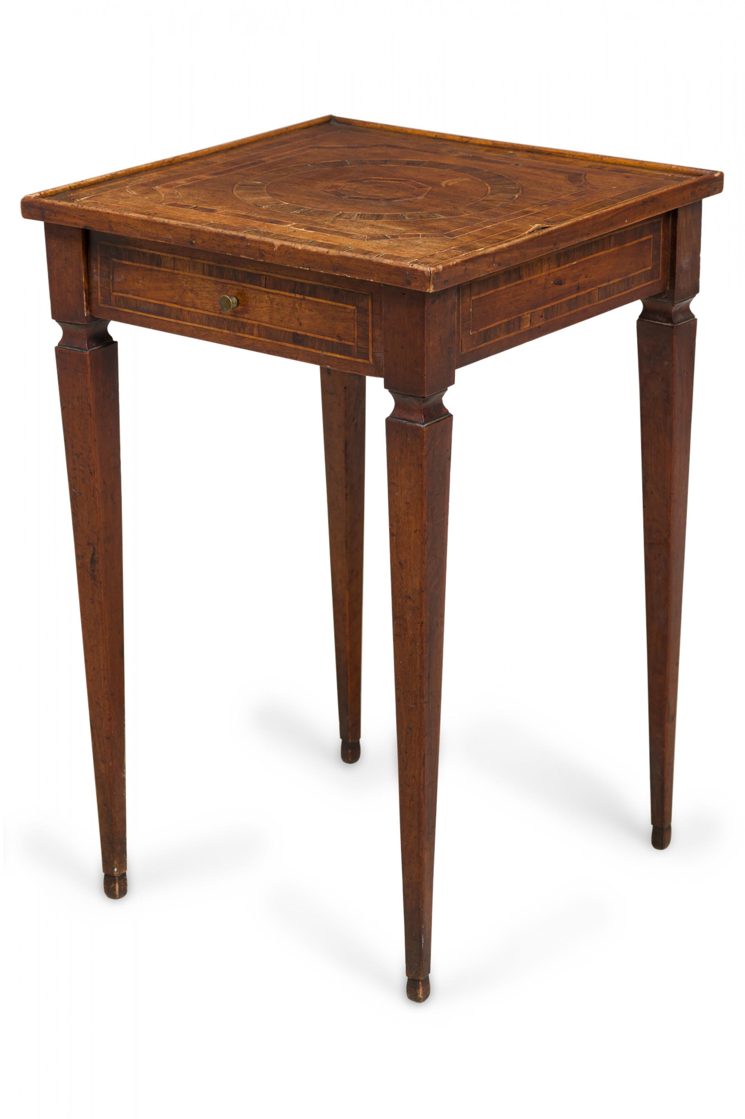 Italian neoclassic (19th century) square walnut end / side table with a top featuring an inlaid design of concentric circles and geometric shapes, an inlaid apron, single drawer with a small brass drawer pull, and square tapered legs.