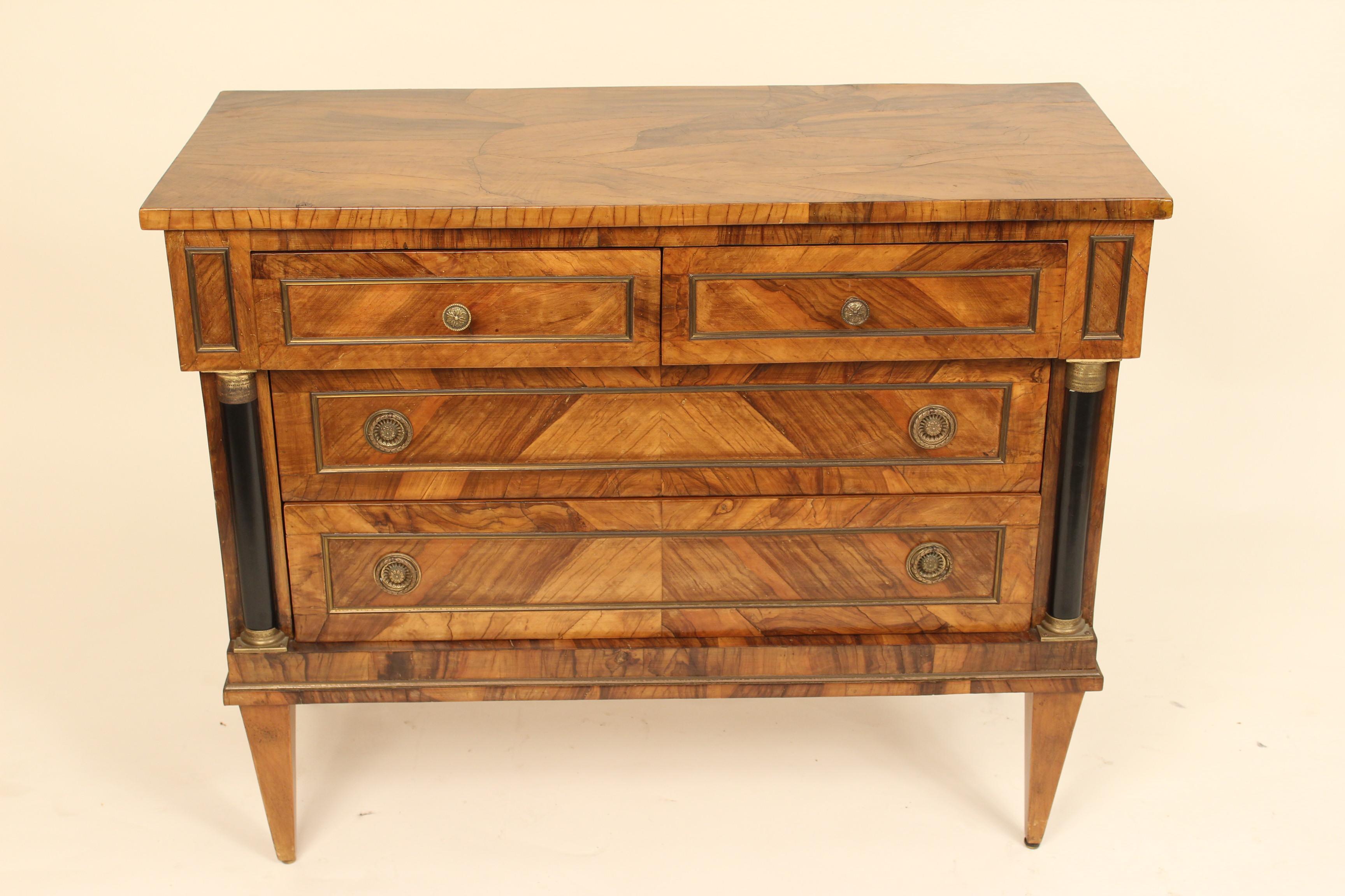 Italian neoclassical style burl olive wood chest of drawers with ebonized columns and brass hardware, mid-20th century.