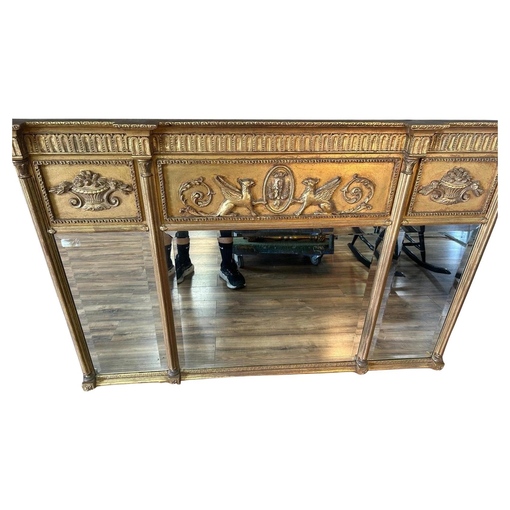 Griffin Motif Three Panel Mantle Mirror. Each panel within the  mirror has a beveled edge. The Giltwood frame is in great condition with gargoyle motifs. Measures approx - 62w x 41h x 3.5d