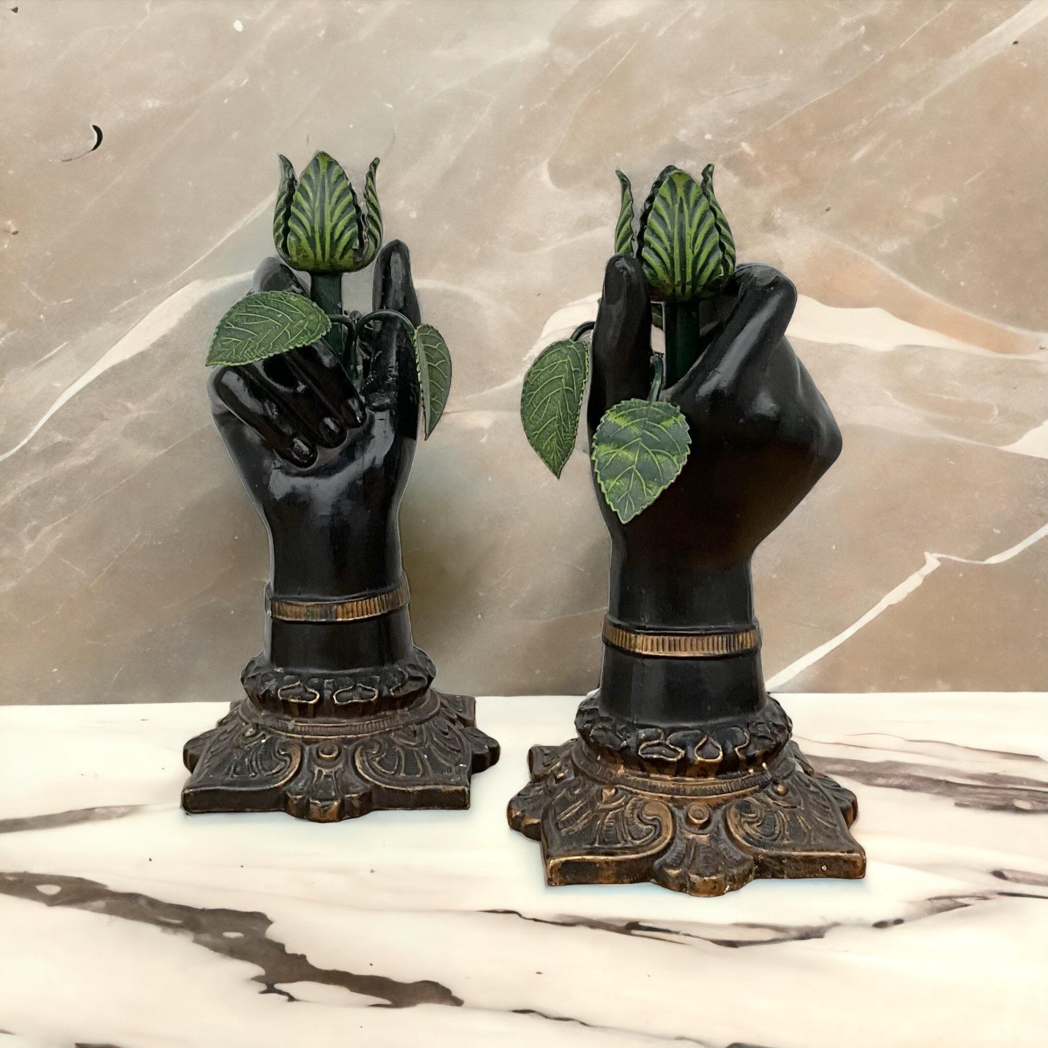 This is a pair of Italian neo-classical style metal tole hand form candlesticks . Each hand is holding a leaf branch. They are in very good condition.