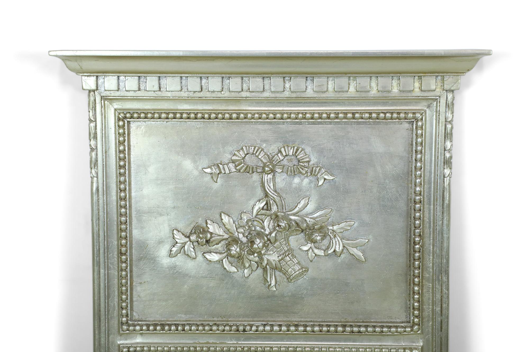 Italian Neo-classical style (20th Century) pier mirror in painted silver with beading and decorative foliate upper section.